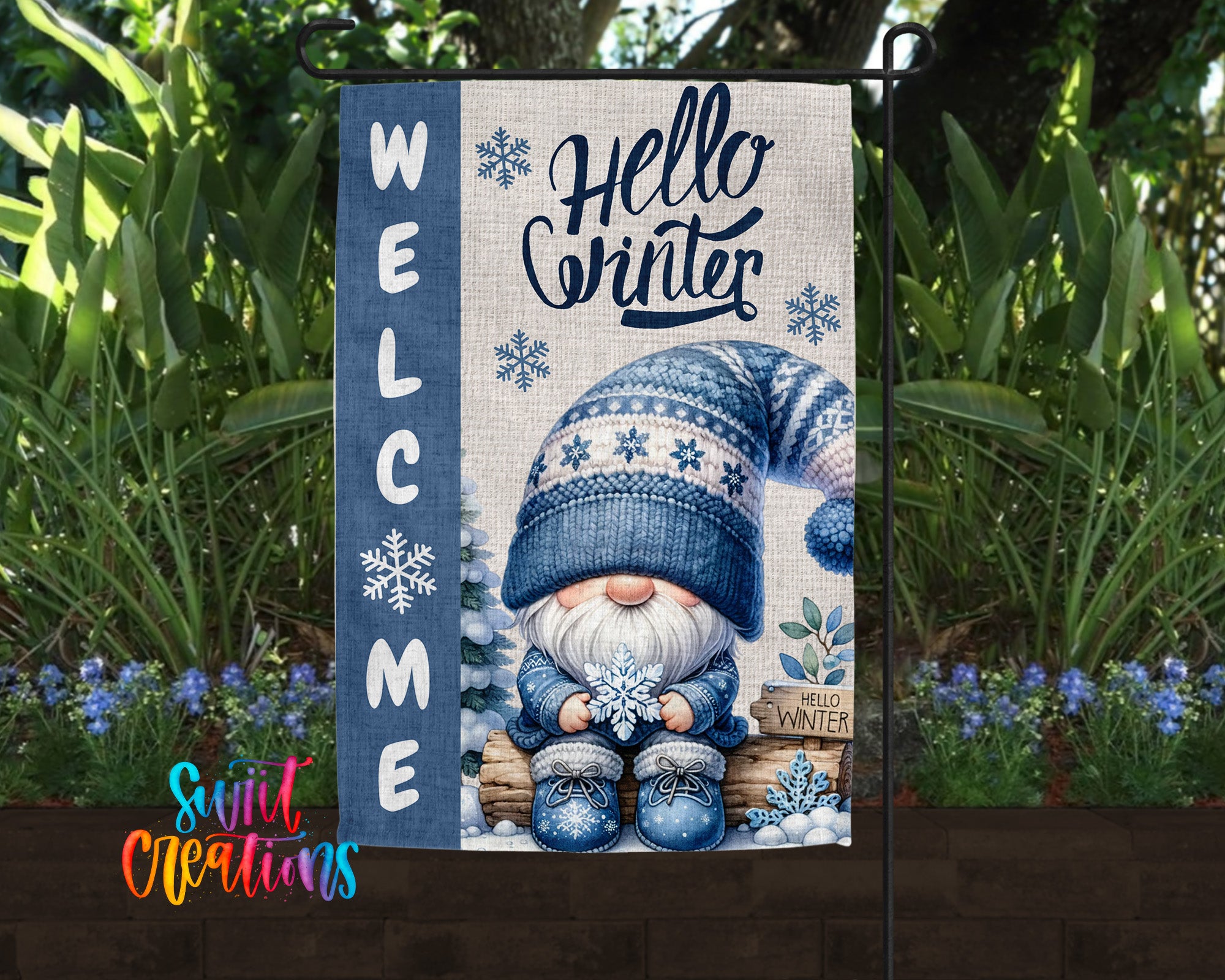 A welcome sign featuring a gnome wearing a winter hat and holding a snowflake, surrounded by snowflakes and flowers.