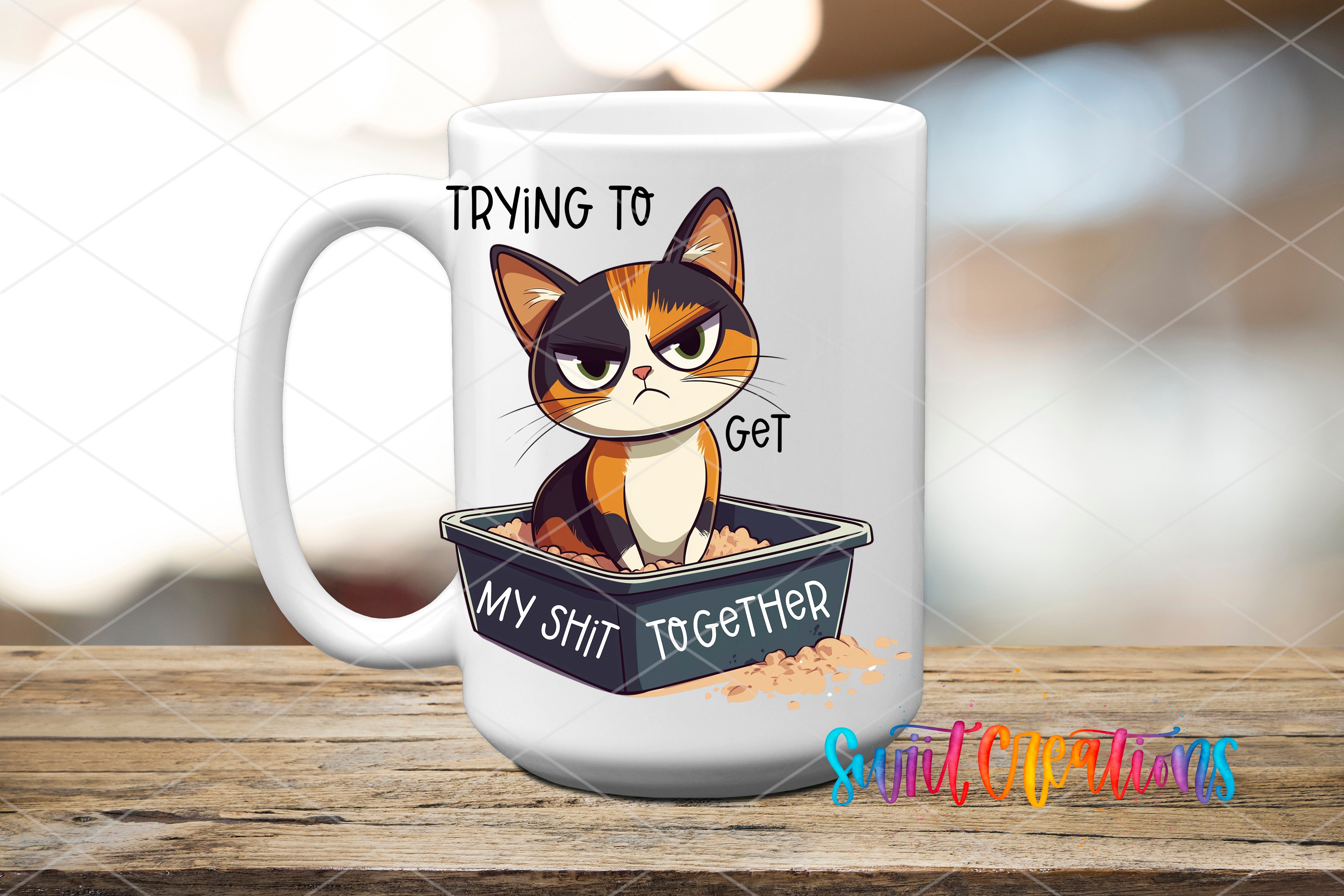 A mug with a cartoon cat sitting in a litter box and the text "Trying to get my shit together" printed on it.
