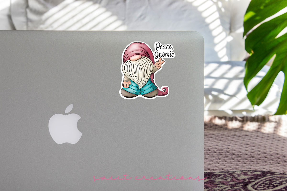 Peace Gnomie sticker on the lid of a silver laptop