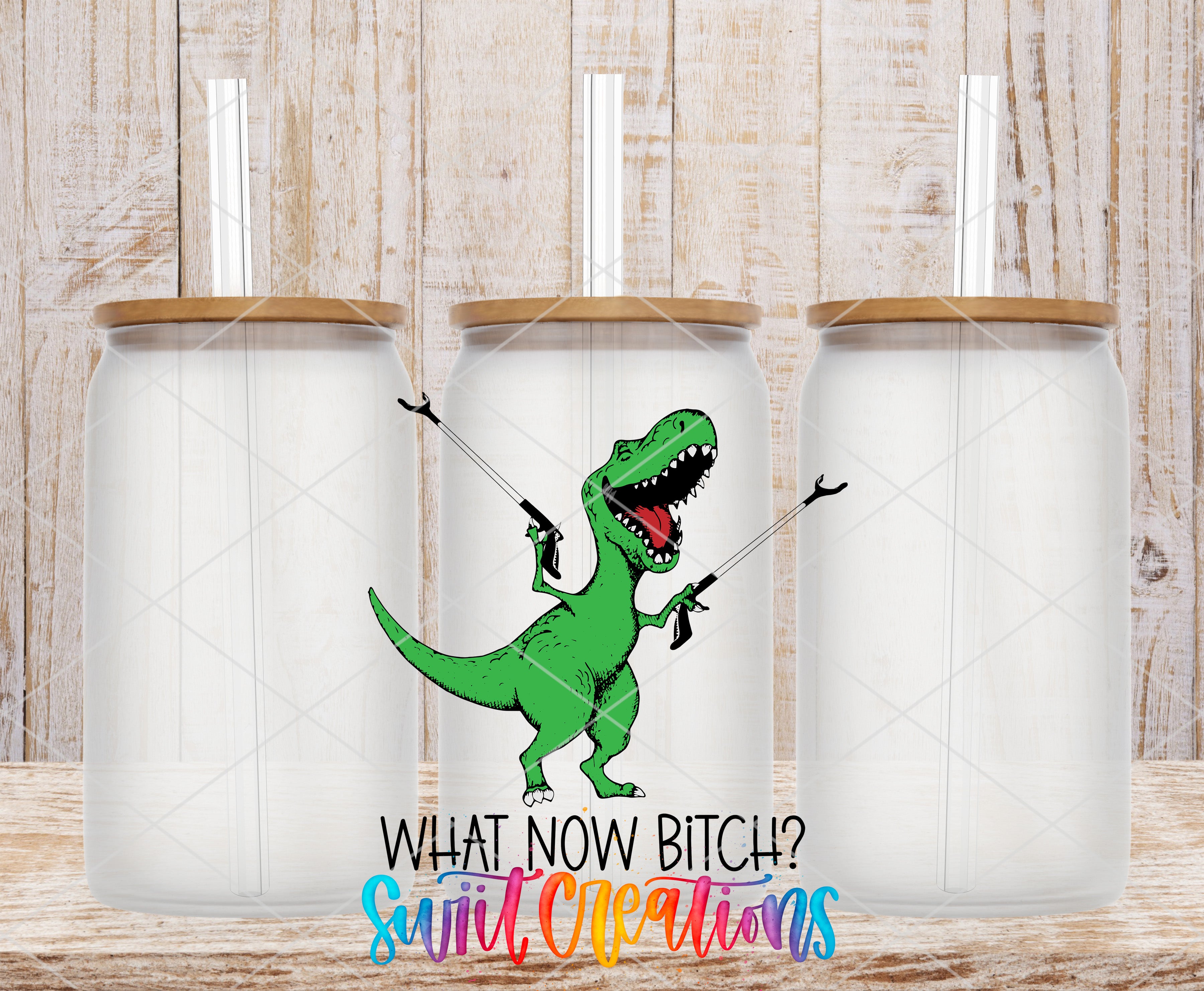 a green dinosaur holding a gun and posing with a question, "What now Bitch? Suit Cleaners", with three identical glass jars in the background.