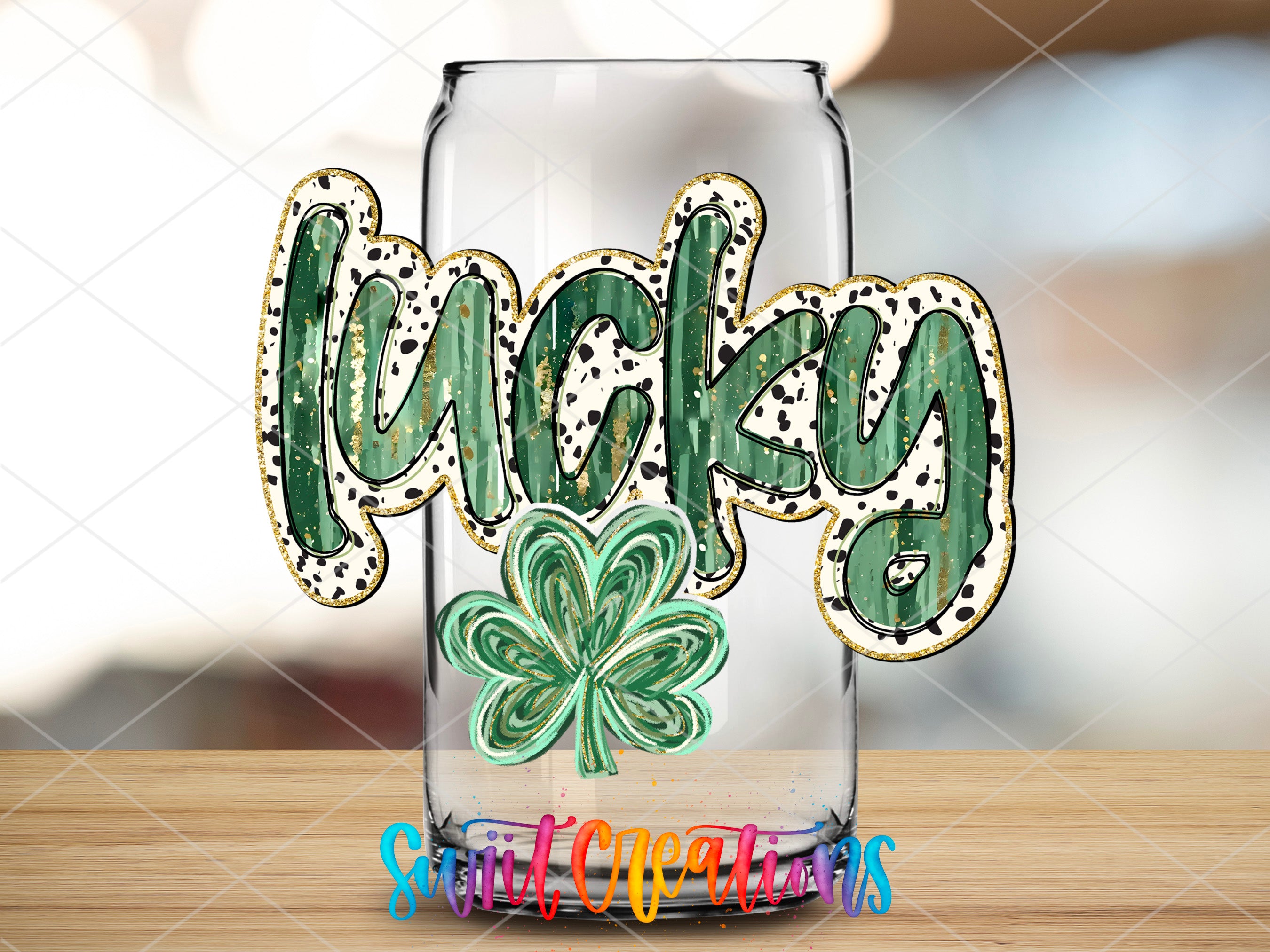 a glass with a shamrock on it sitting on a table