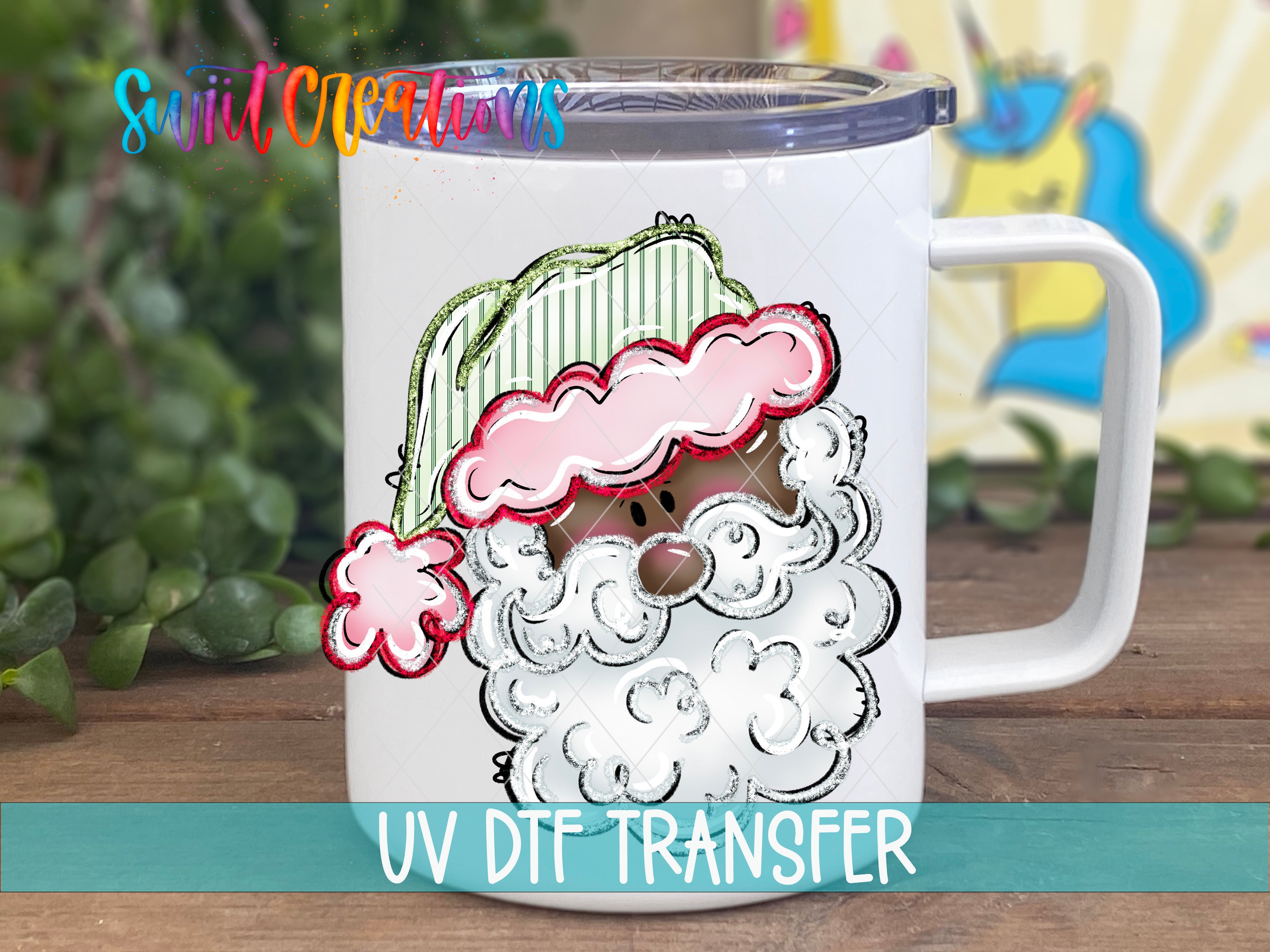 A white mug with a colorful Santa Claus design printed on it, sitting on a wooden surface.