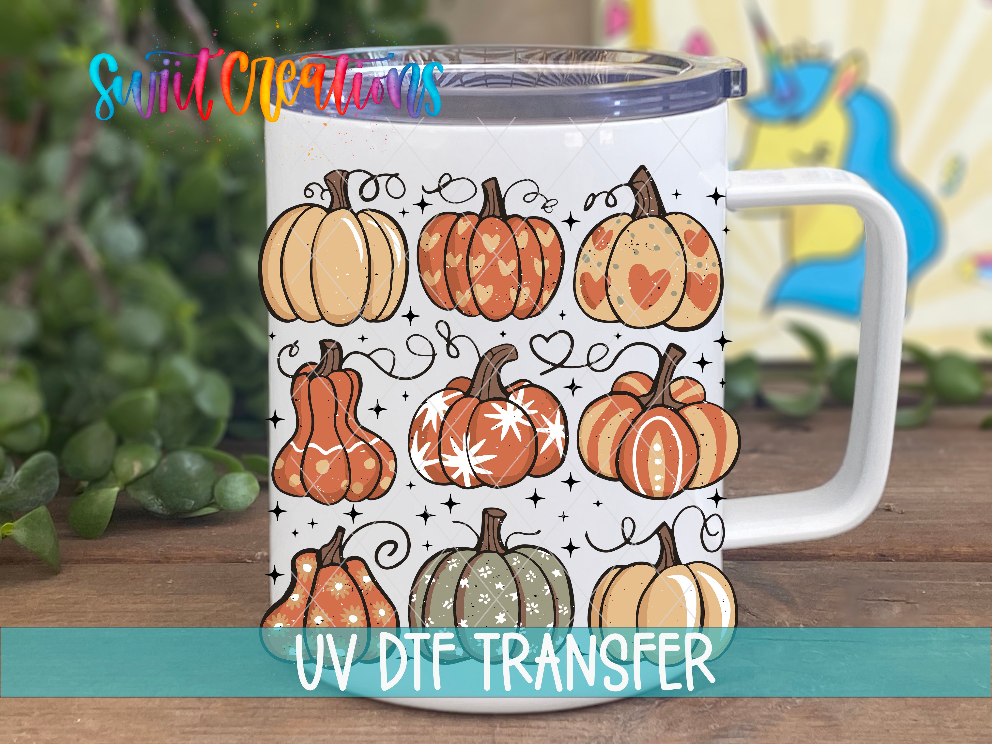 A white mug with a design of various pumpkins and stars on it, placed on a wooden surface.