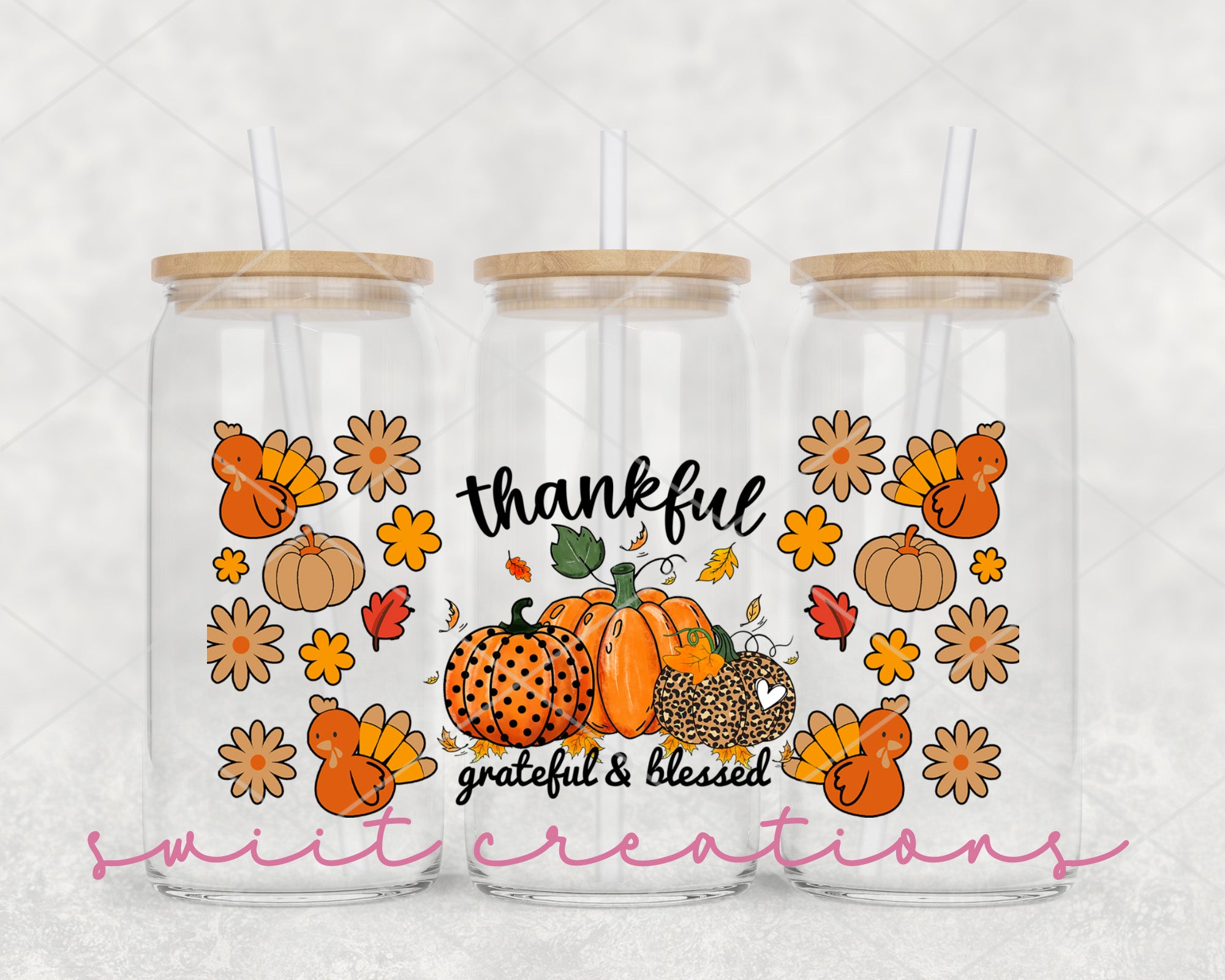 a set of two tumblers with a picture of pumpkins and leaves on them