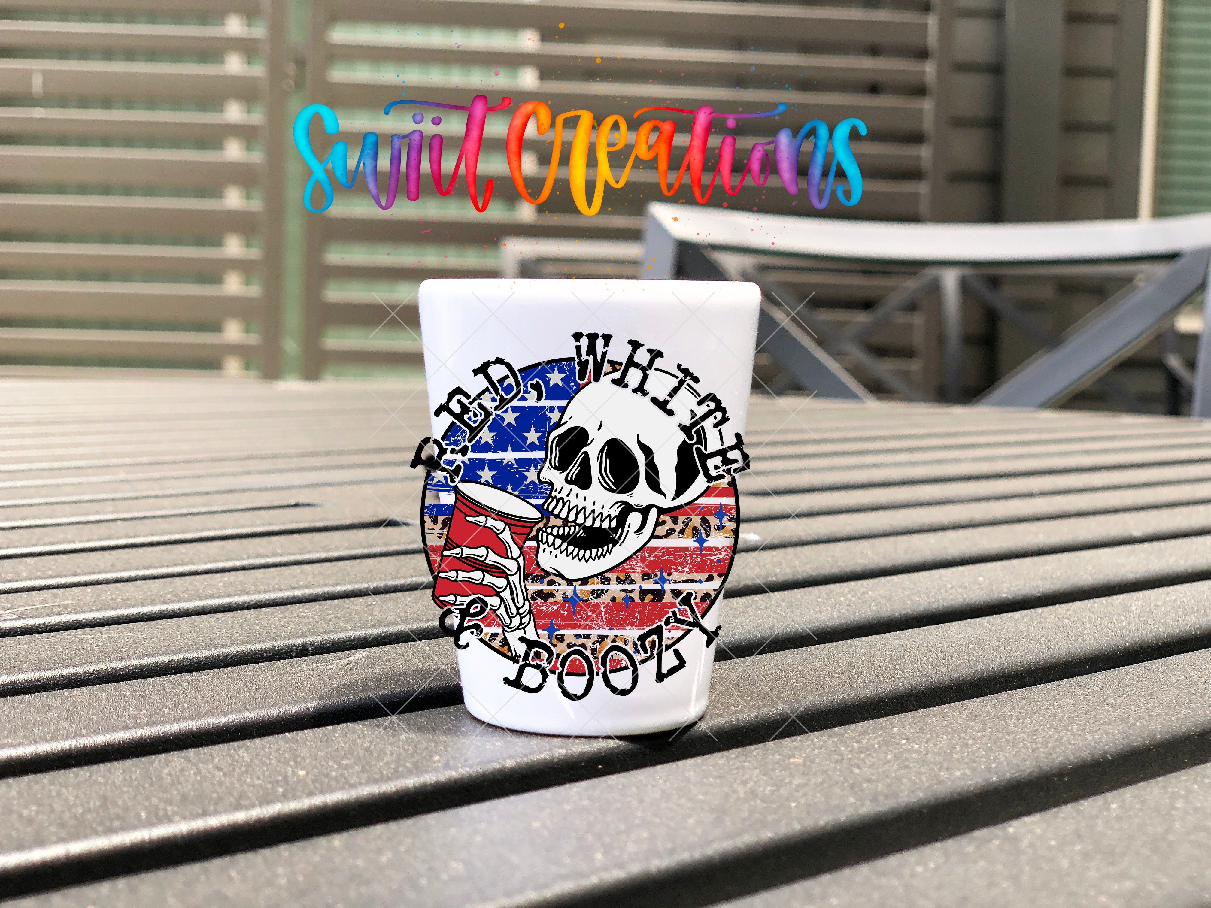 a cup with a skull on it sitting on a bench