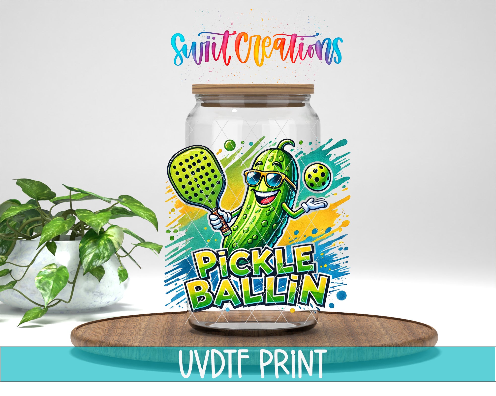 a glass jar with a cartoon pickle wearing sunglasses and holding a tennis racket, surrounded by splashes of color and text that reads "Pickle Ballin".