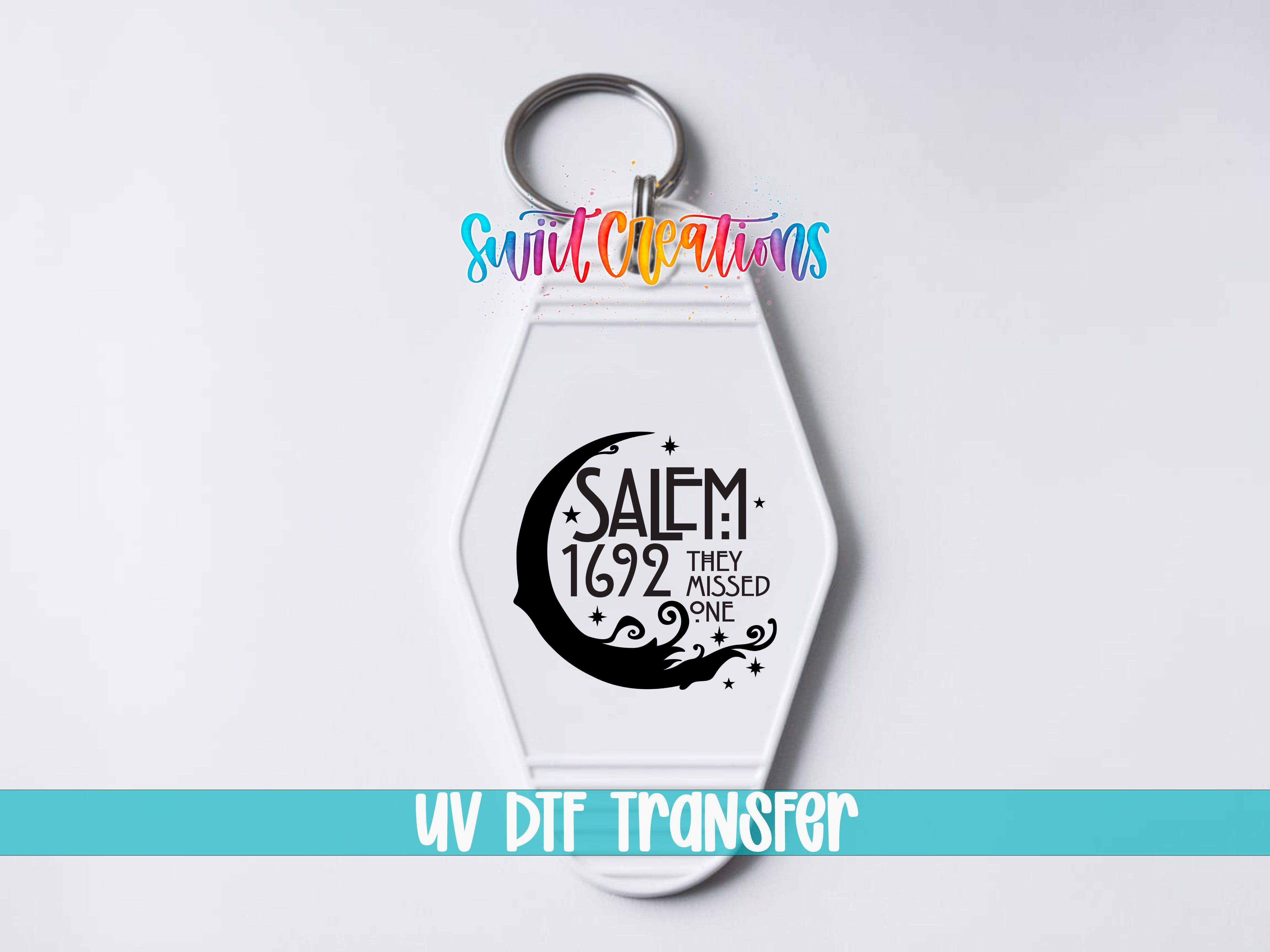 A keychain with a design featuring a crescent moon and the text "SALEM 1692 THEY MISSED ONE" printed on it.