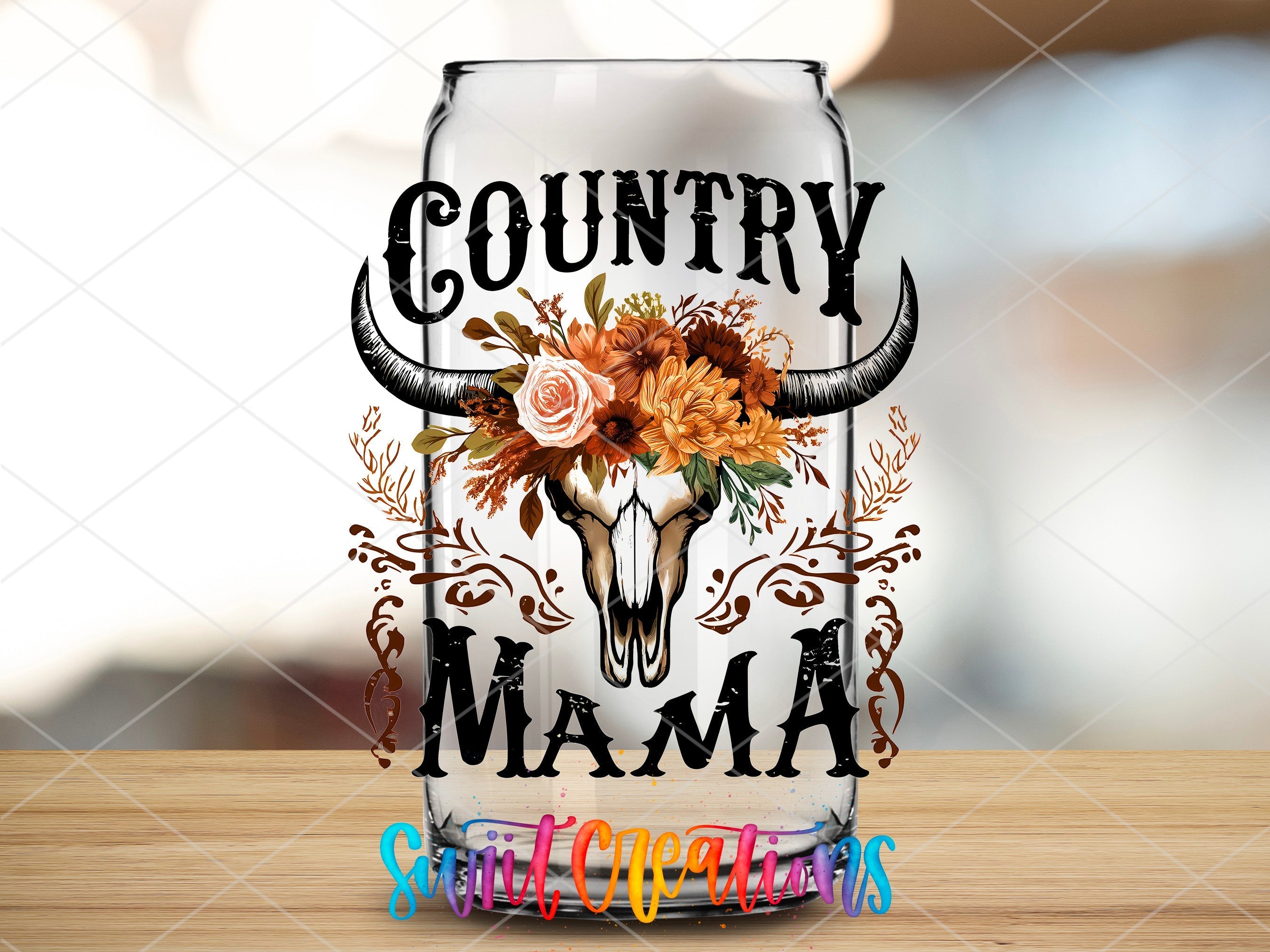 a beer glass with a cow skull and flowers on it