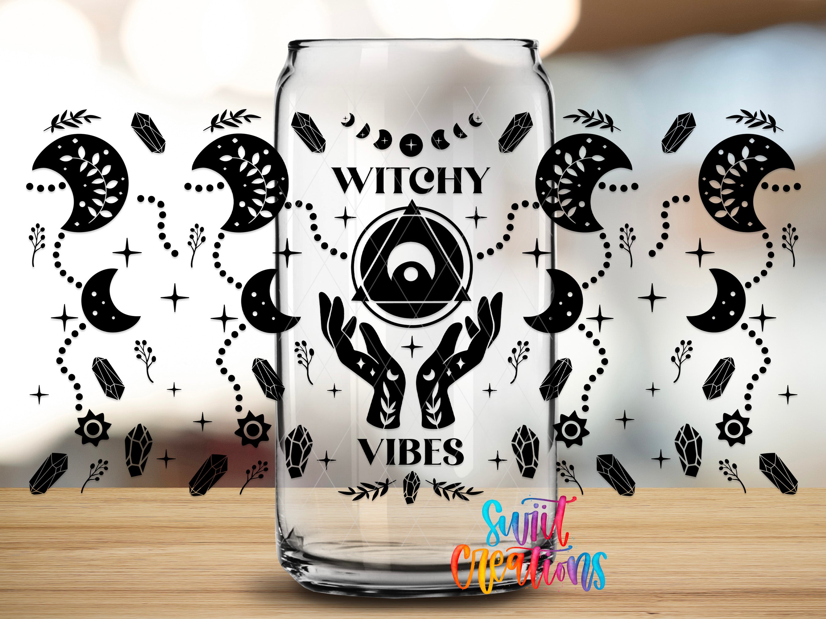 A glass can with the text "Witchy Vibes" printed on it, surrounded by various mystical and supernatural symbols and designs.