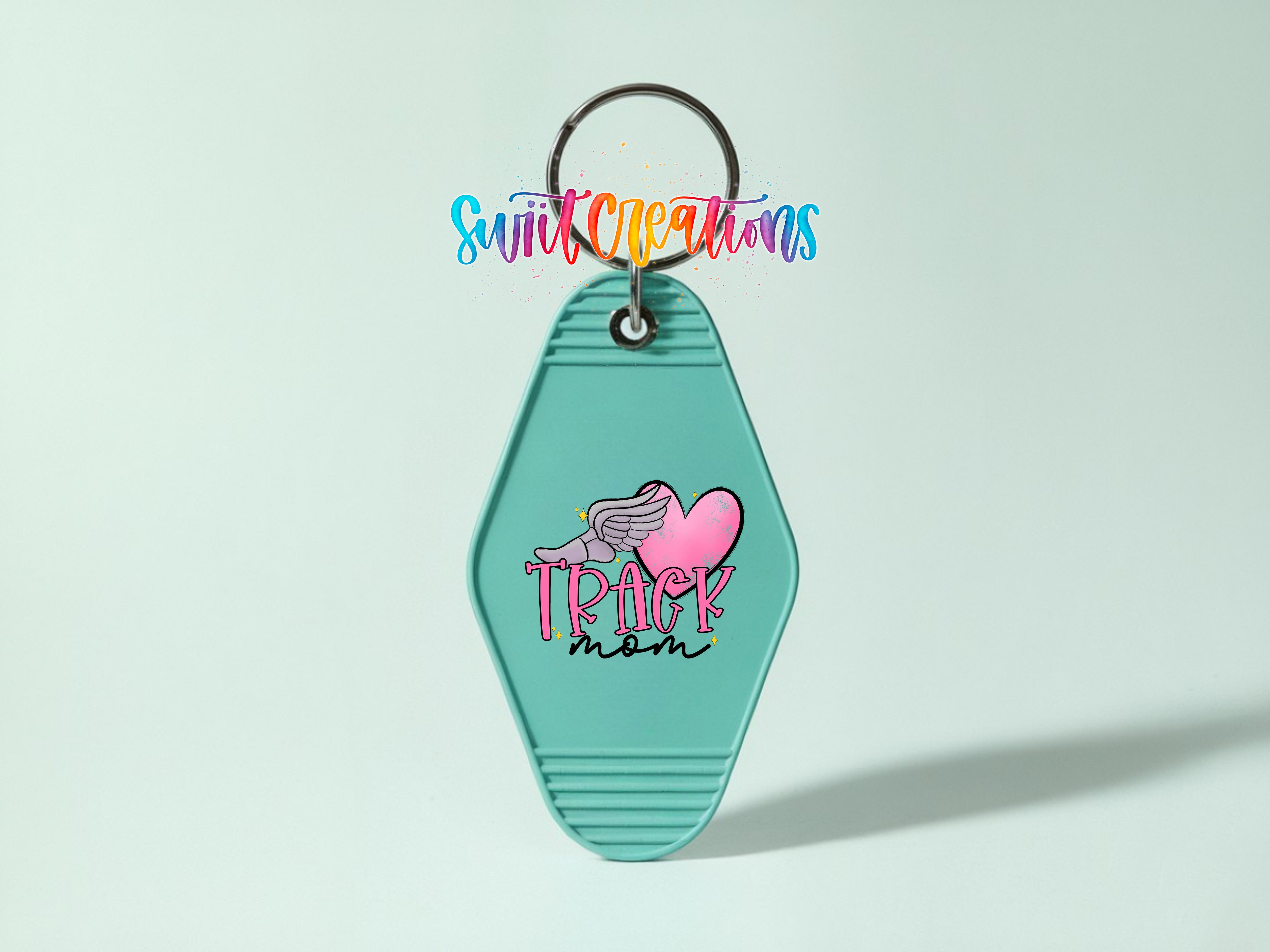A turquoise keychain with a heart-shaped design and the text "TRACK mom" printed on it.