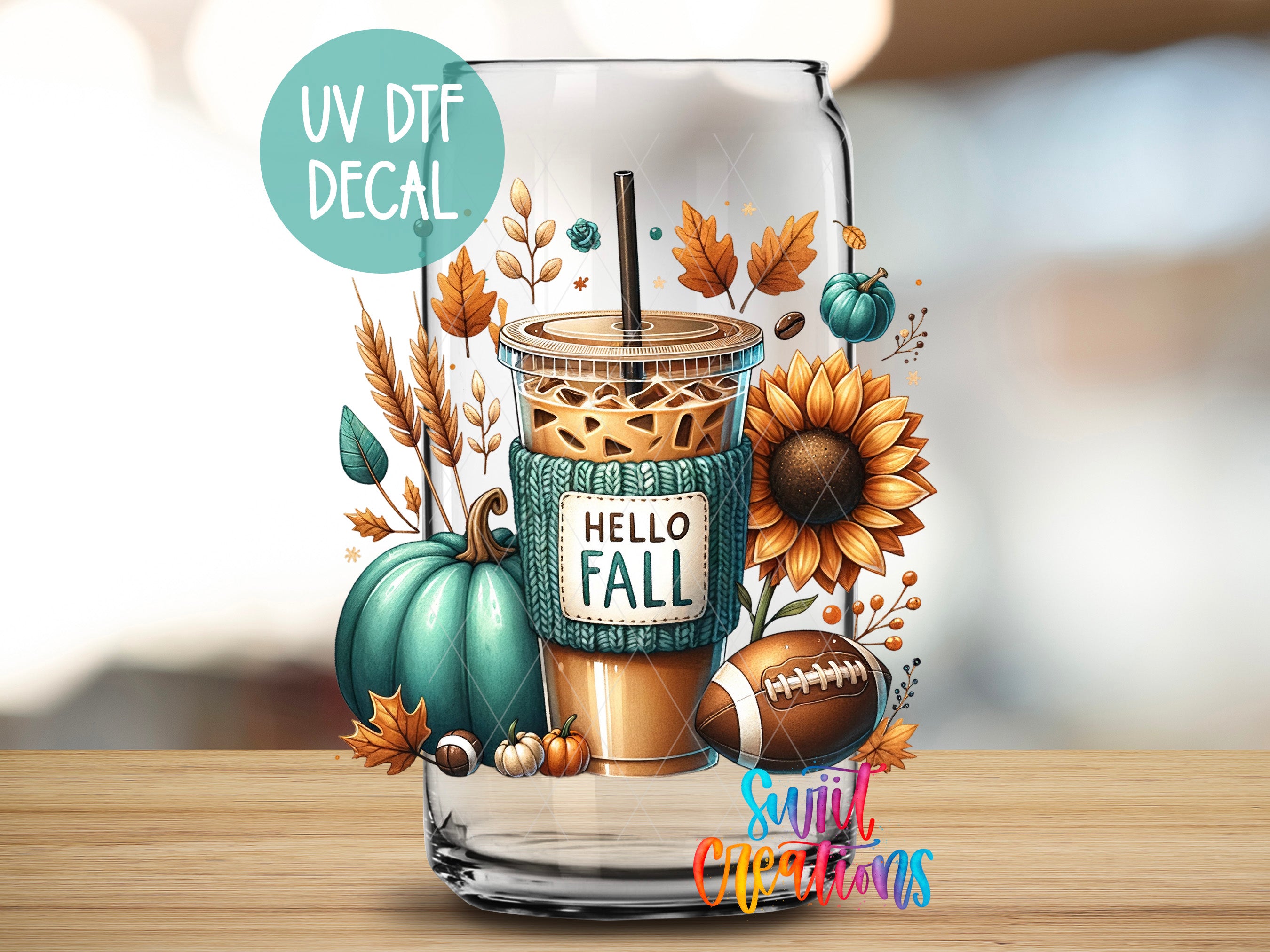 A glass with a coffee drink and autumn-themed decorations, including a sunflower, pumpkin, and football, along with the text "Hello Fall" and "UV Dtf Decal".