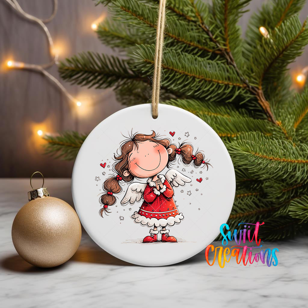 A white ceramic ornament featuring a smiling girl with long hair and wings, surrounded by Christmas lights and a pine tree.