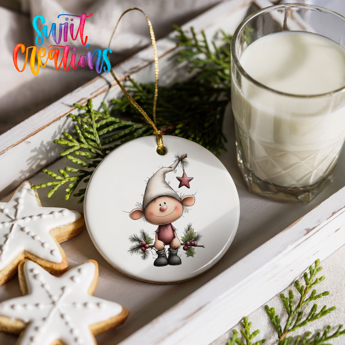 a festive scene with a white ornament depicting a smiling gnome, a glass of milk, and some cookies.