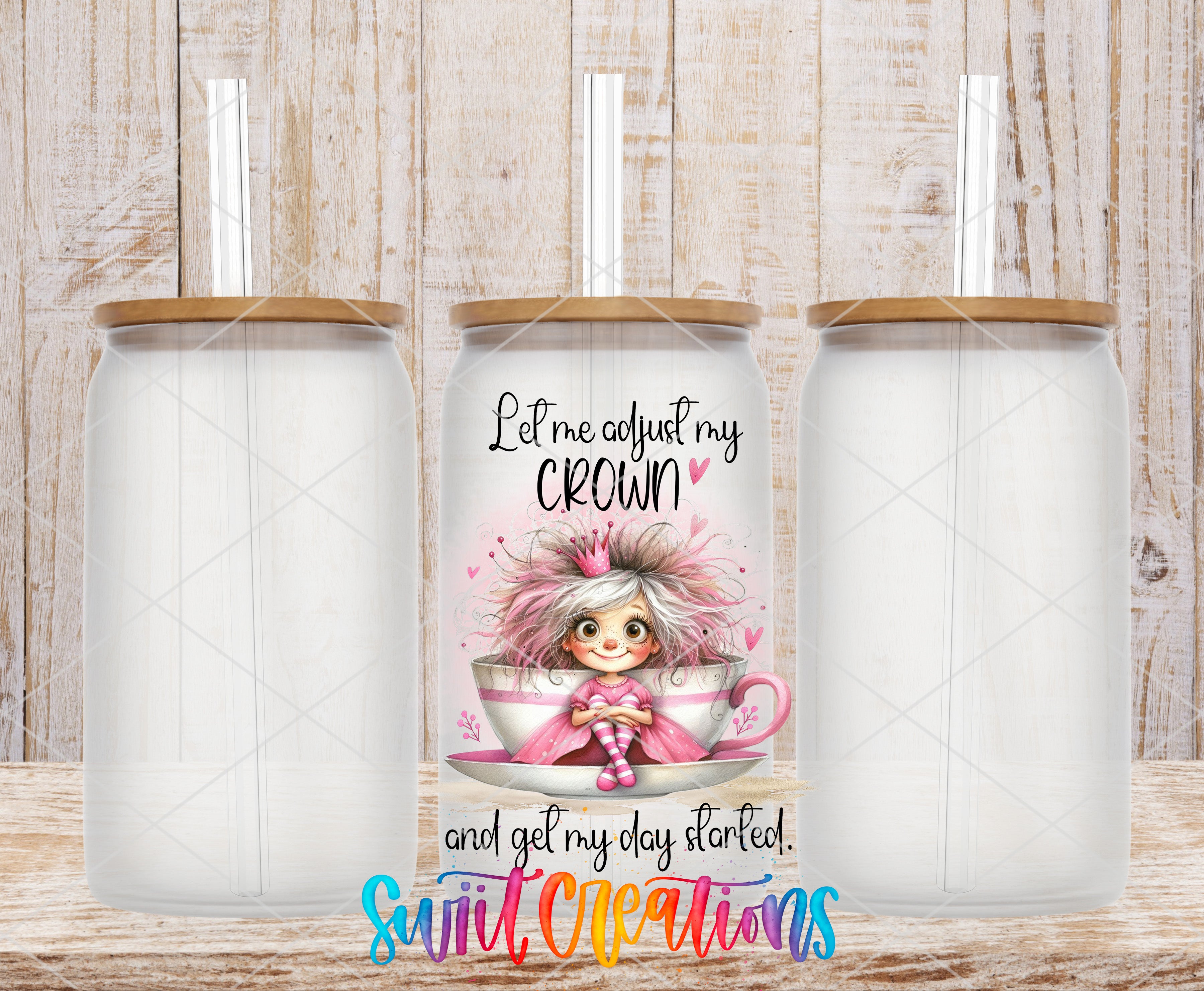 a clear glass mug with a straw, and there is a printed design on the mug that includes a cartoon character and text.