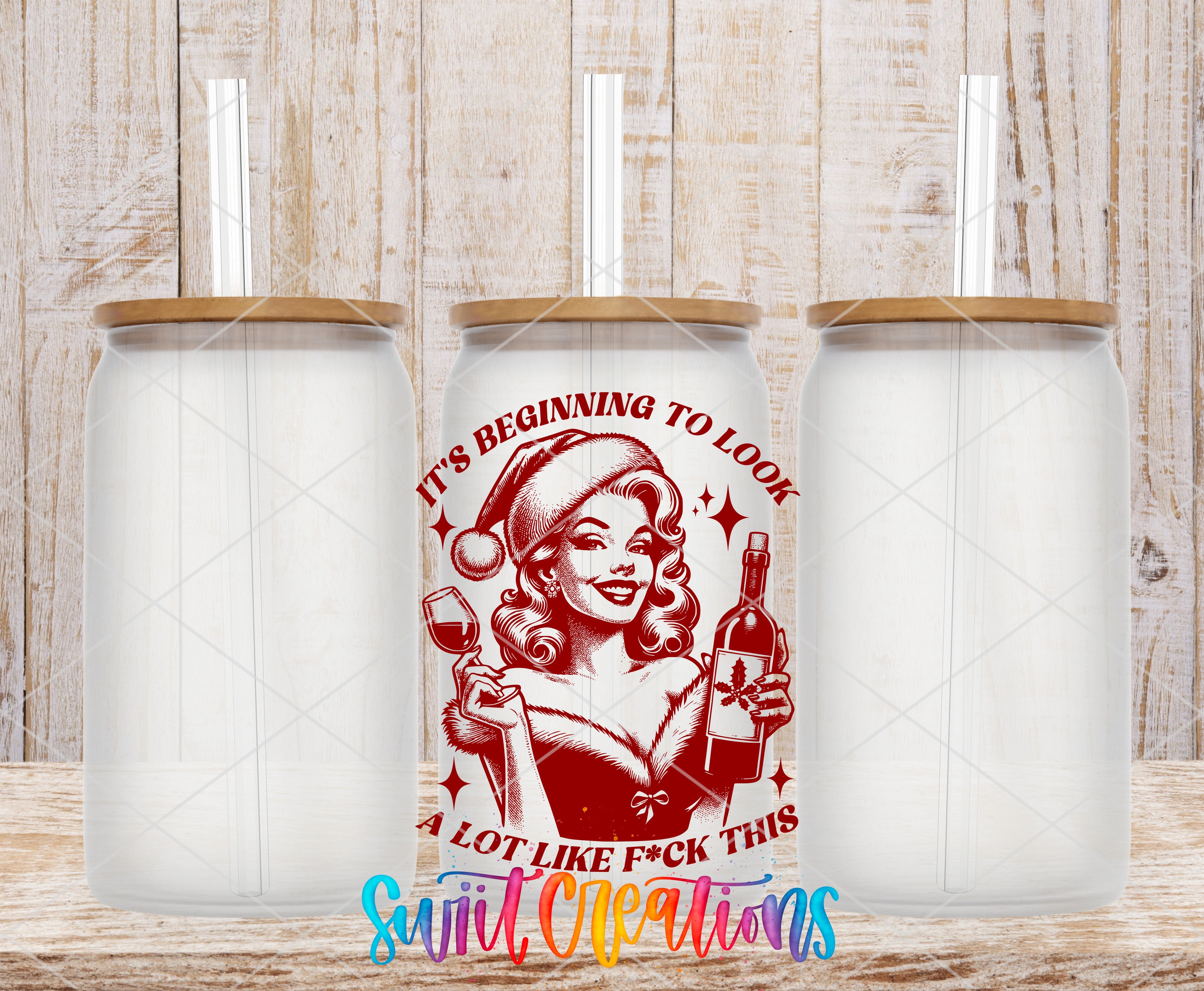a red and white tumbler with a cartoon illustration of a woman holding a wine glass and a bottle of alcohol, along with the text "It's Beginning to Look Like F*ck This" and "A Lot Like F*ck This" printed on it.