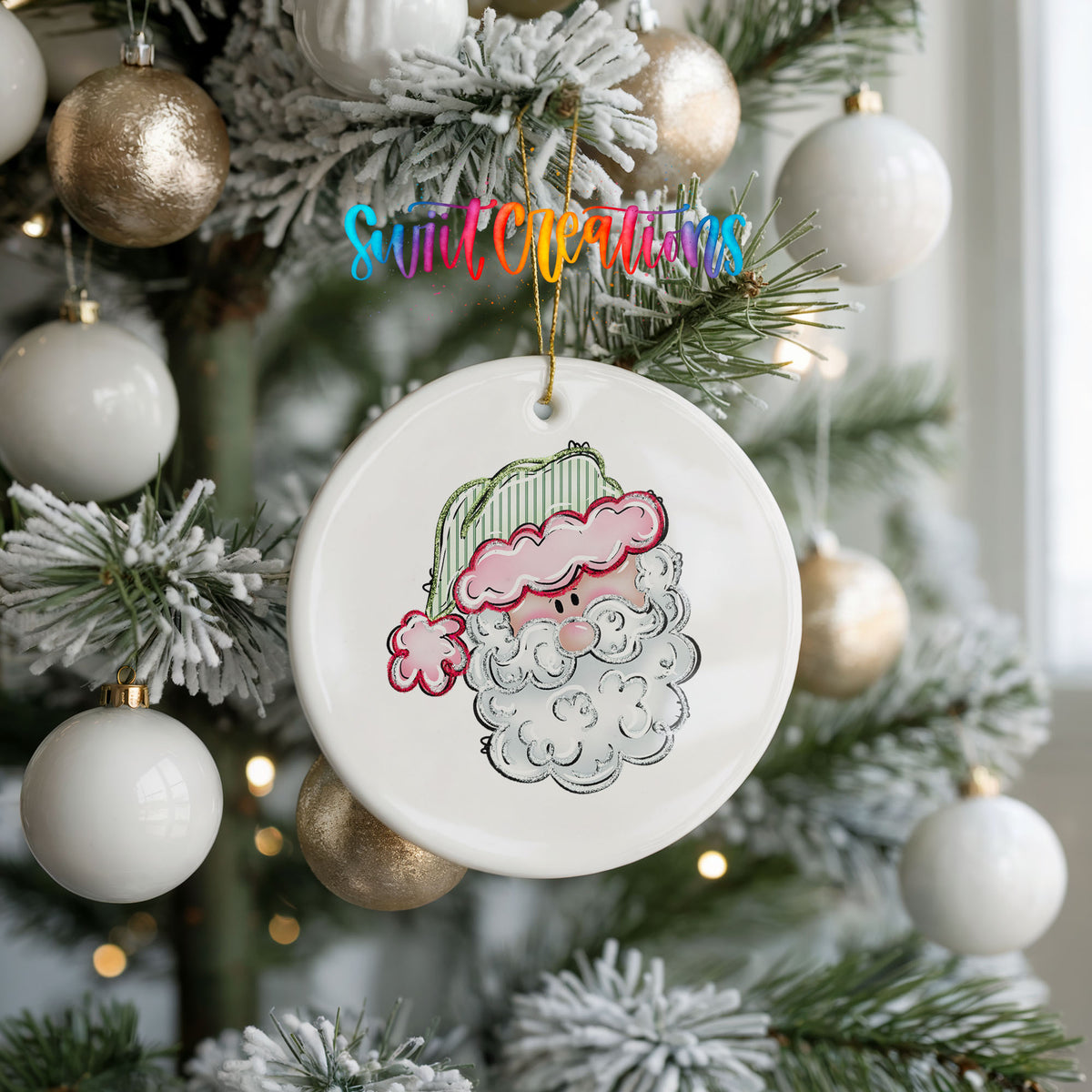 A white ceramic ornament with a Santa Claus face is hanging on a Christmas tree, surrounded by white and gold ornaments.