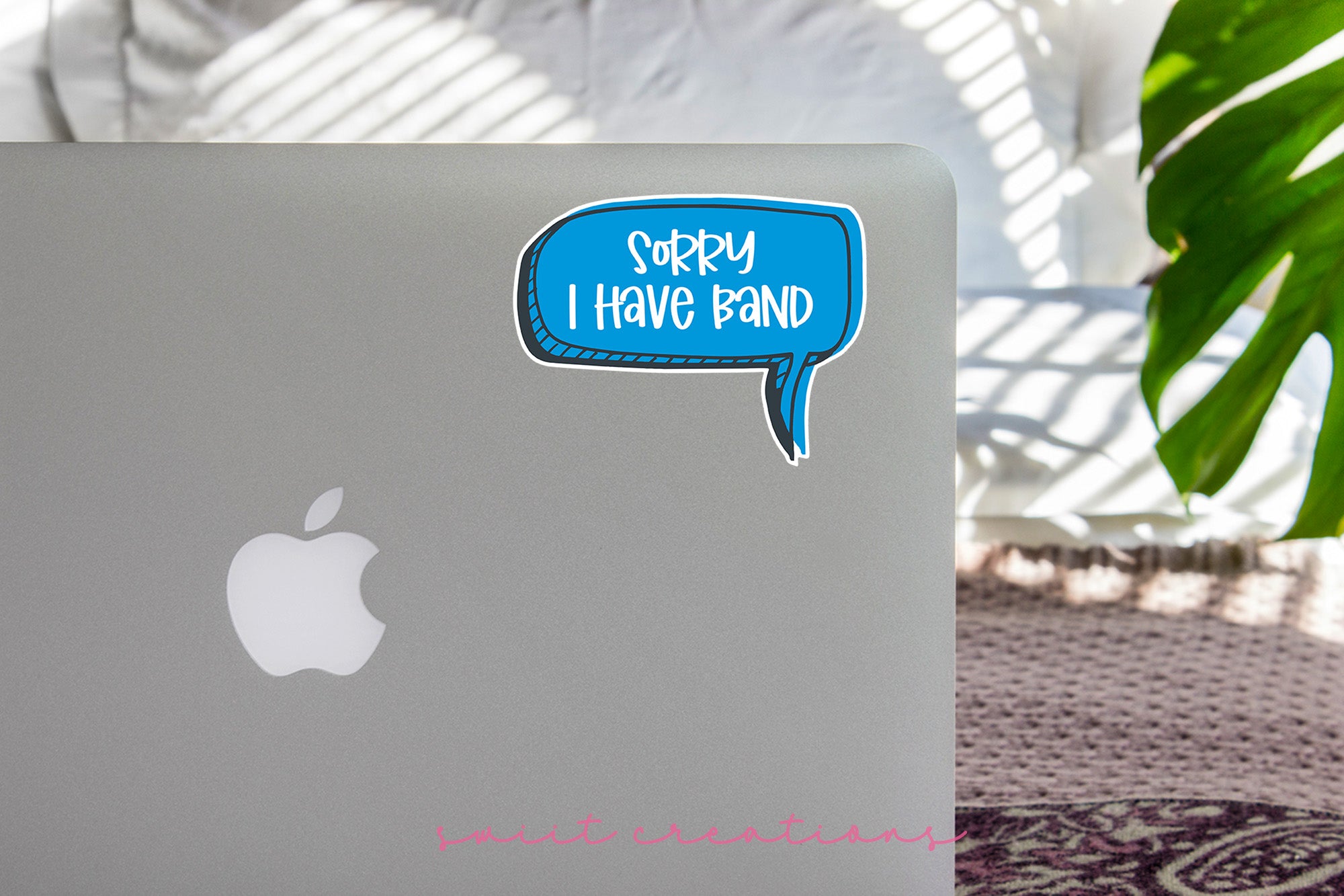 a laptop with a speech bubble sticker on it
