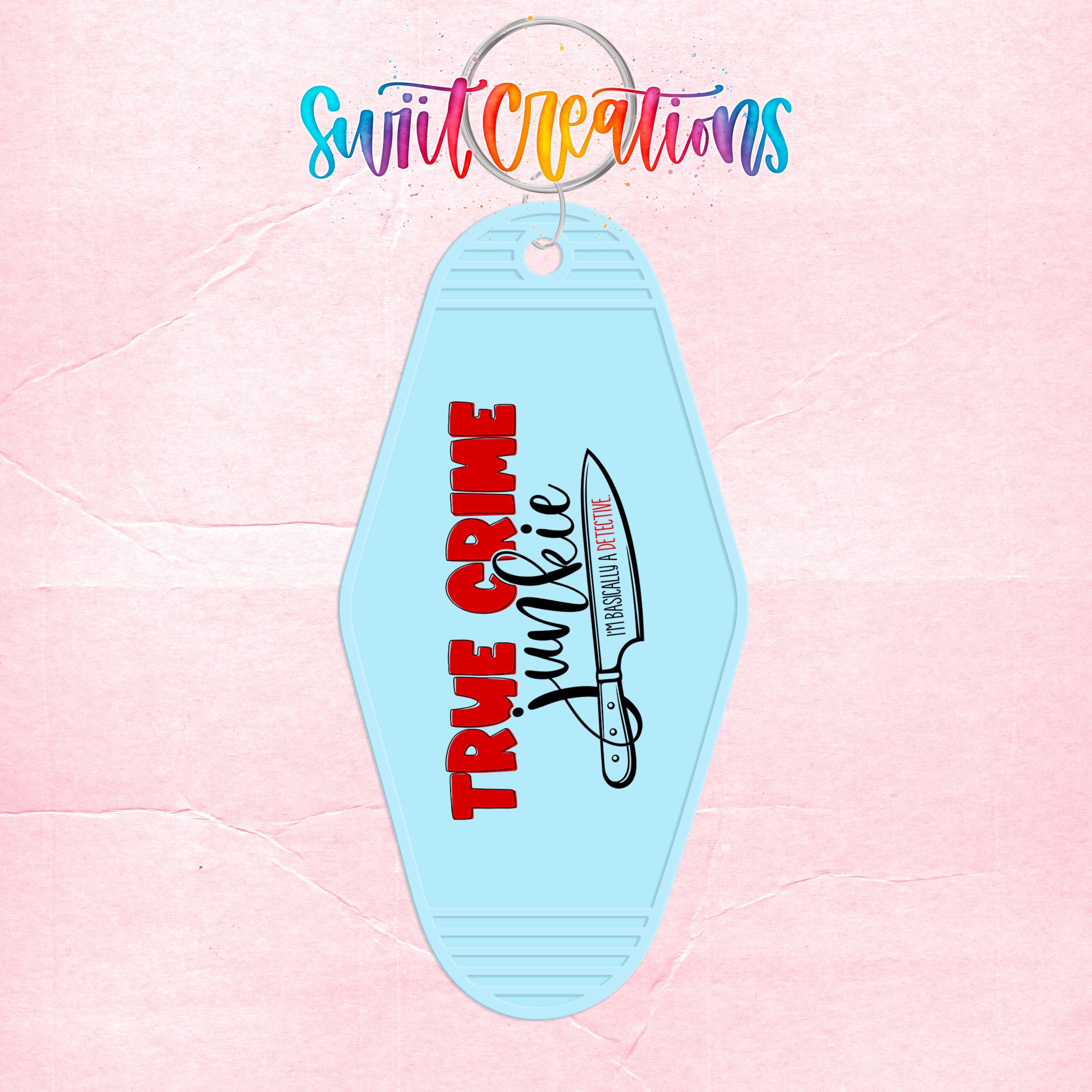 A keychain with the text "TRUE CRIME" and a graphic of a knife, against a pink background.