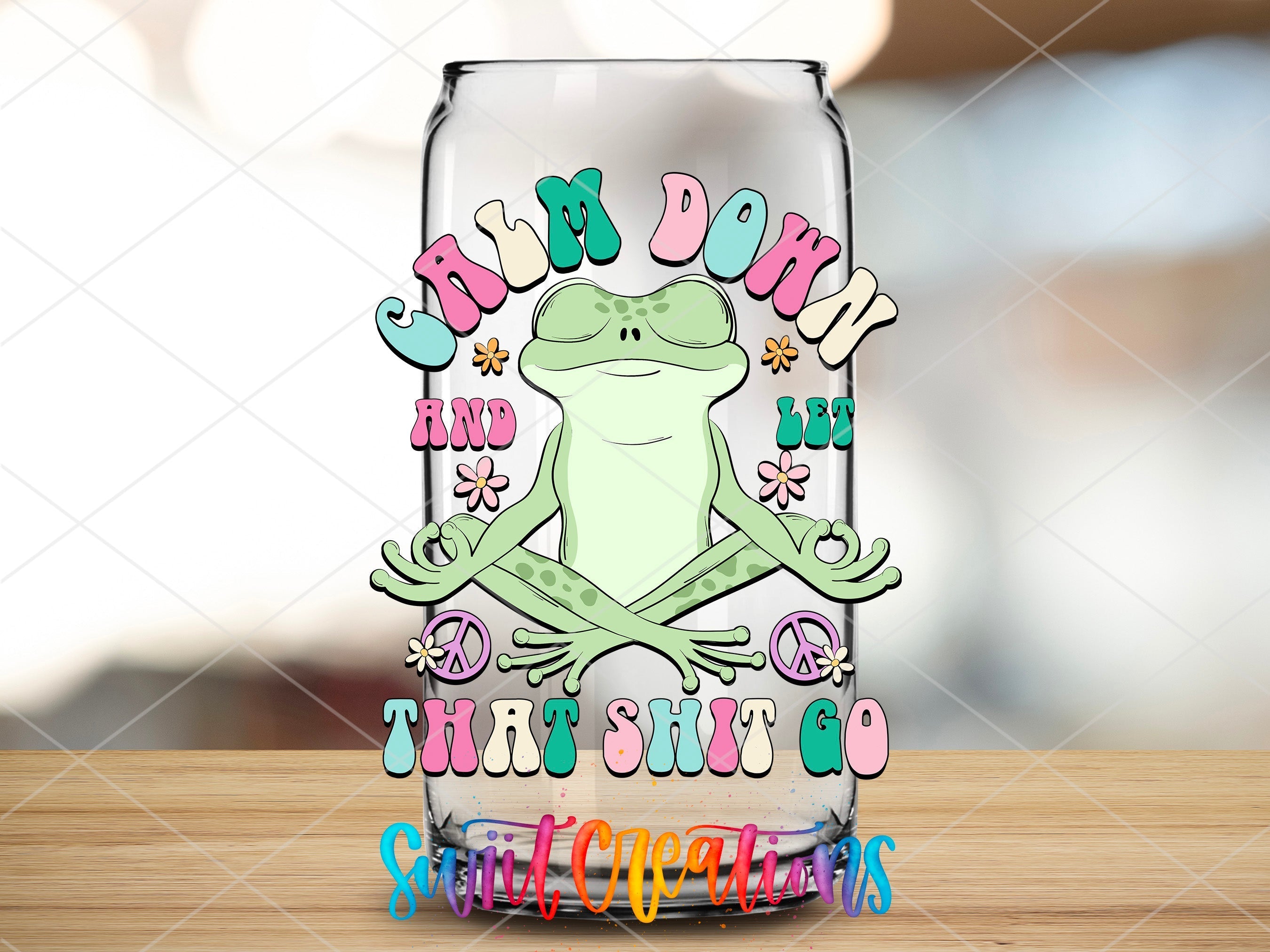 a glass with a frog sitting on top of it