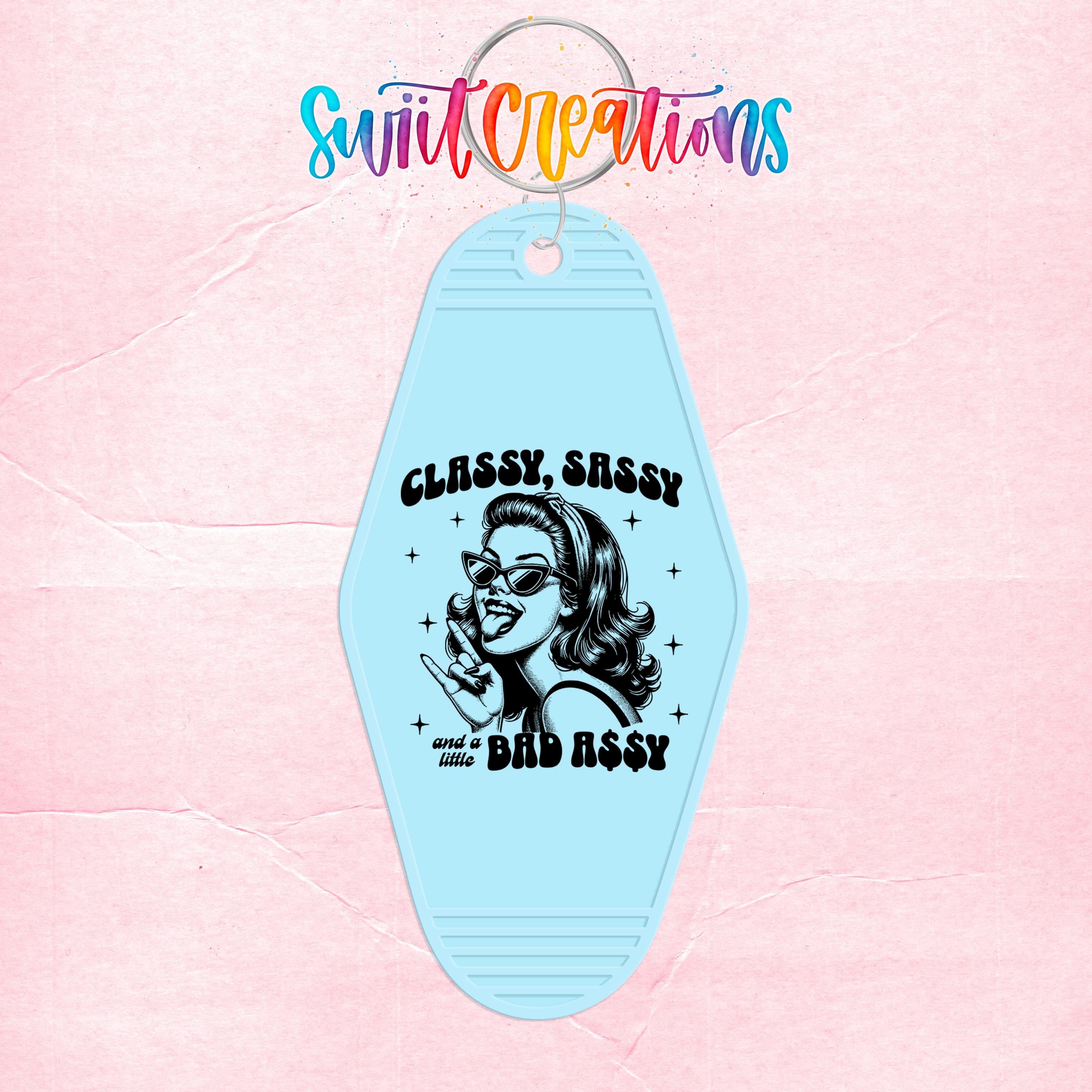A keychain with a design featuring a woman with sunglasses and the text "CLASSY SASSY AND A BAD ASSY" printed on it.