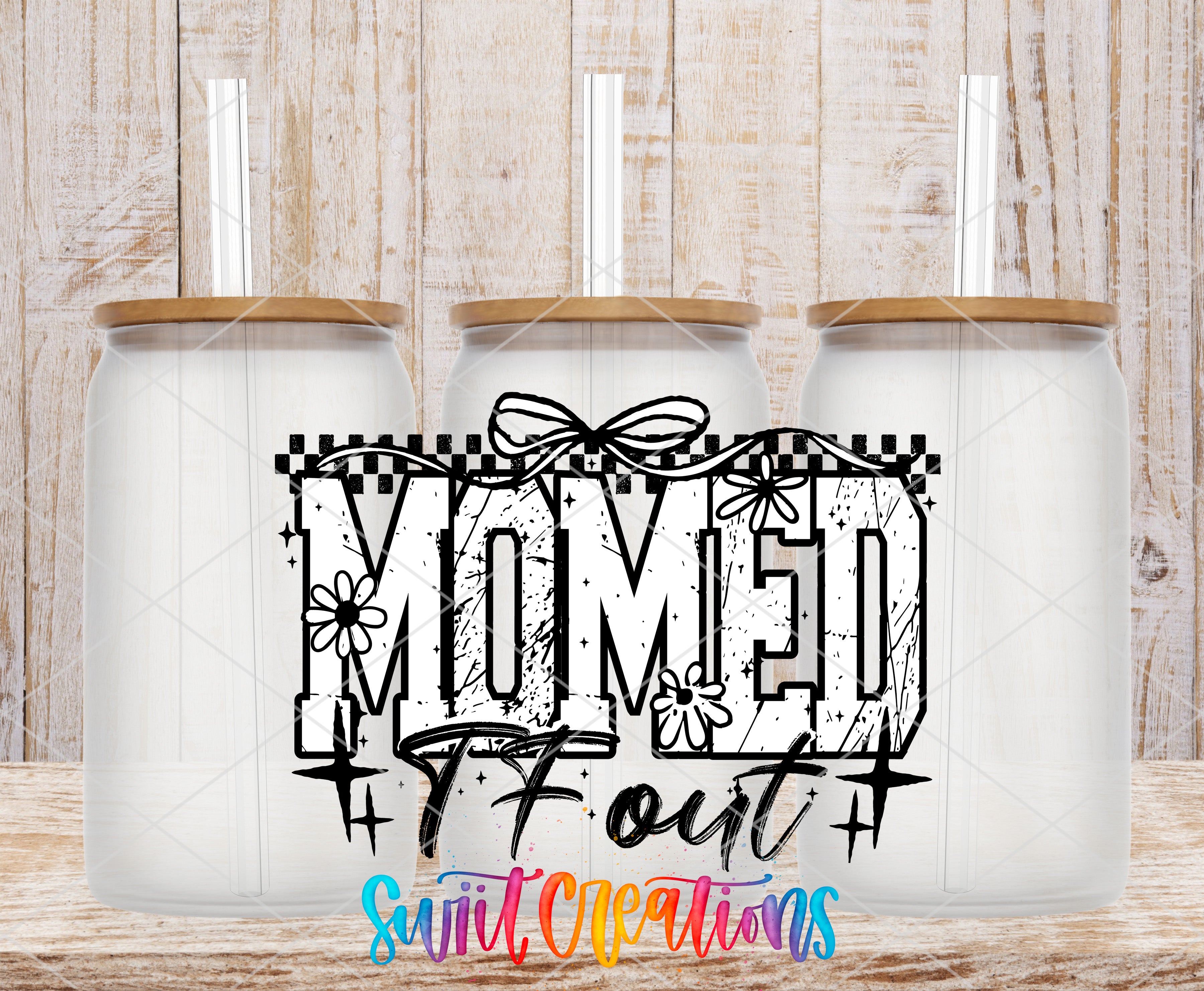 three glass jars with lids, arranged in a row against a wooden background. The jars have a white color and appear to be made of glass. The text "MOMED" is prominently displayed in the center of the image, with the word "OUT" written below it.