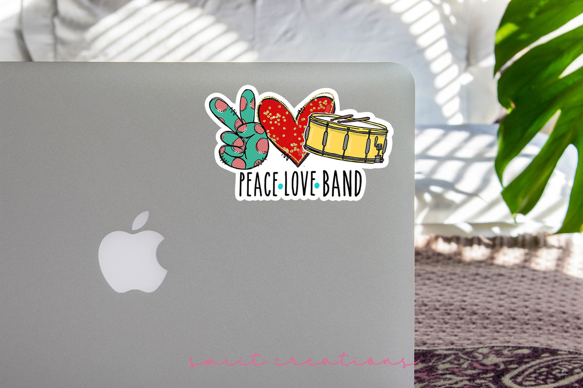 Peace Love Band sticker on the lid of a silver laptop