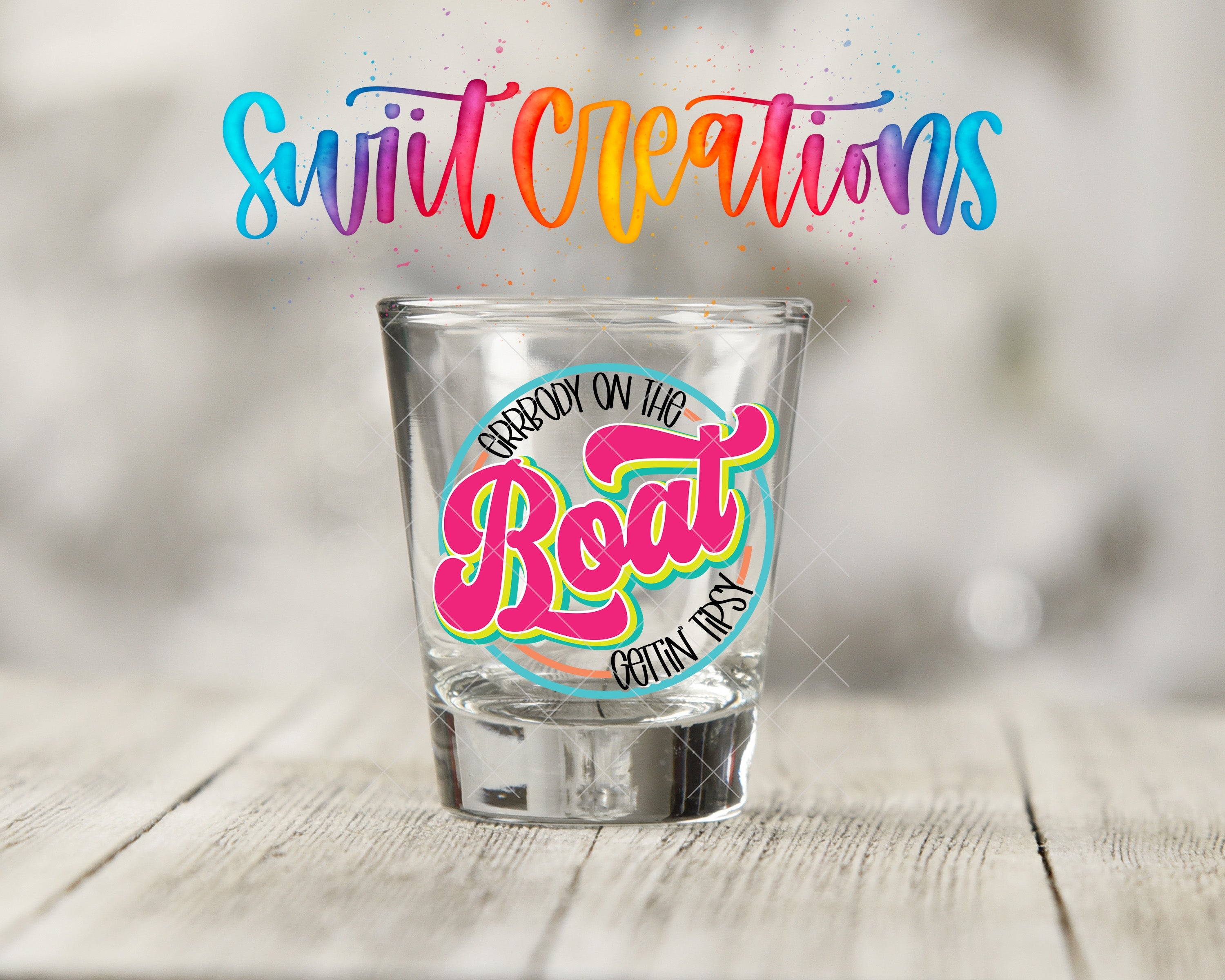 a shot glass sitting on top of a wooden table