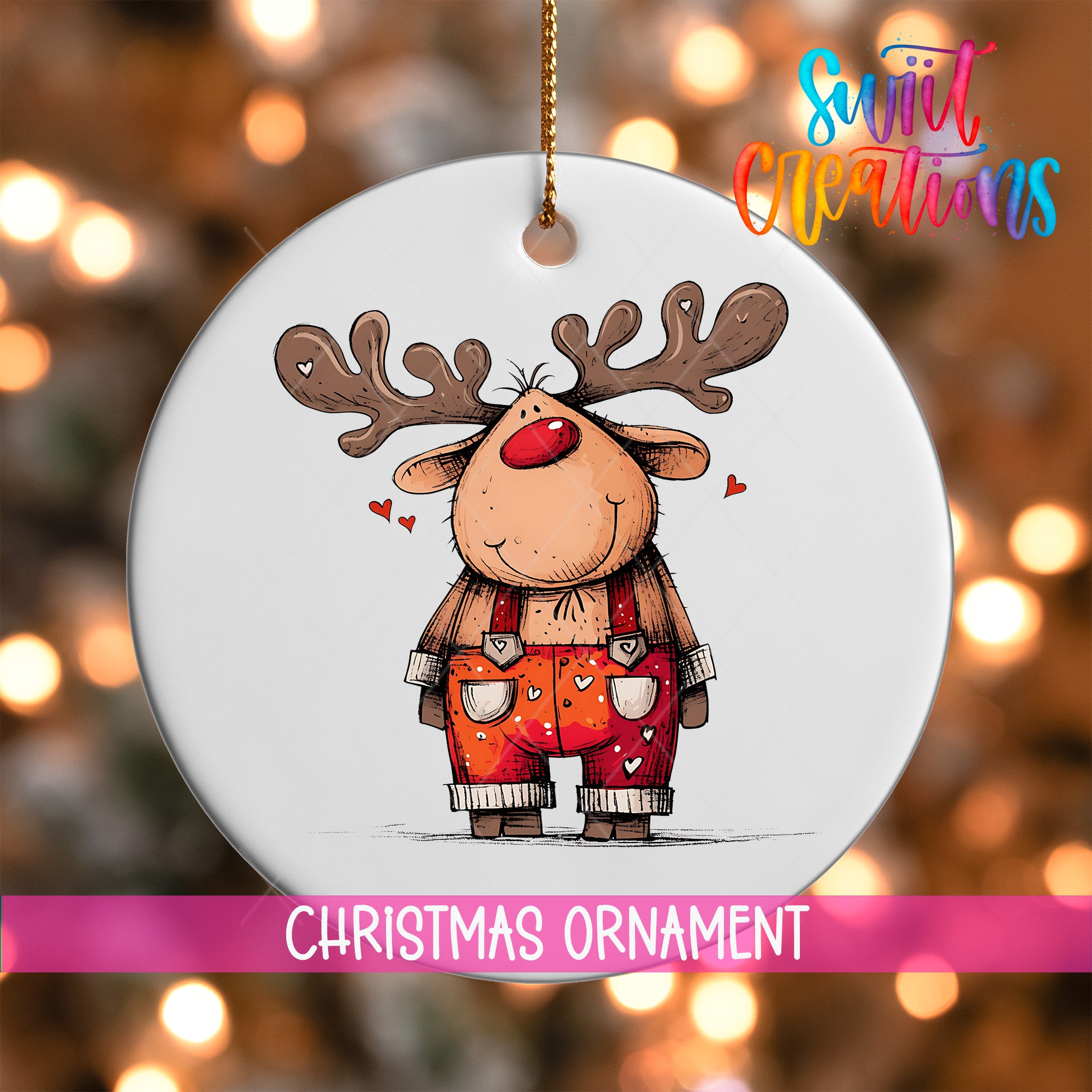 A white Christmas ornament featuring a cartoon reindeer with antlers and a red nose, wearing orange overalls with hearts on them.