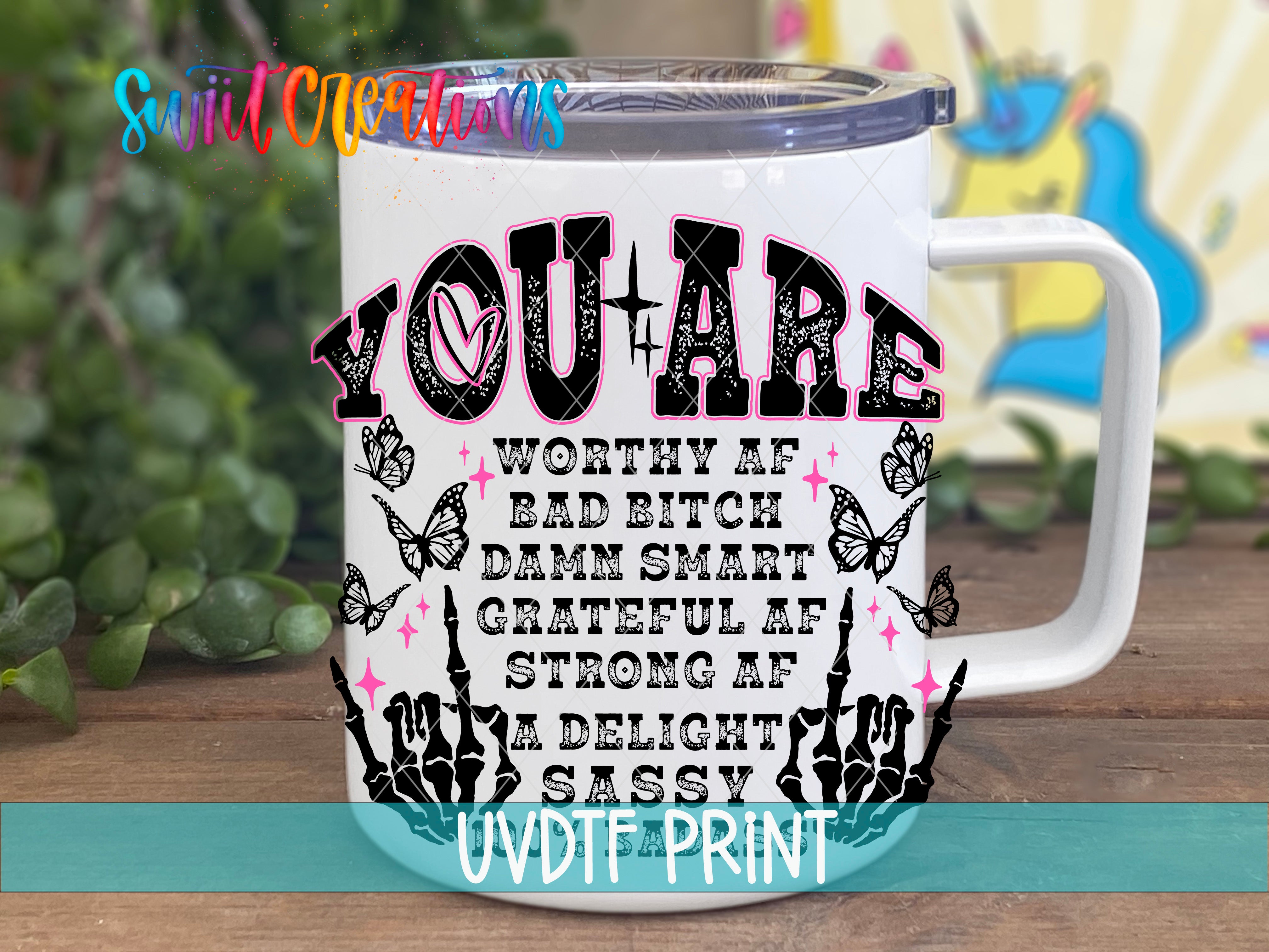 a white coffee mug with pink lettering on it