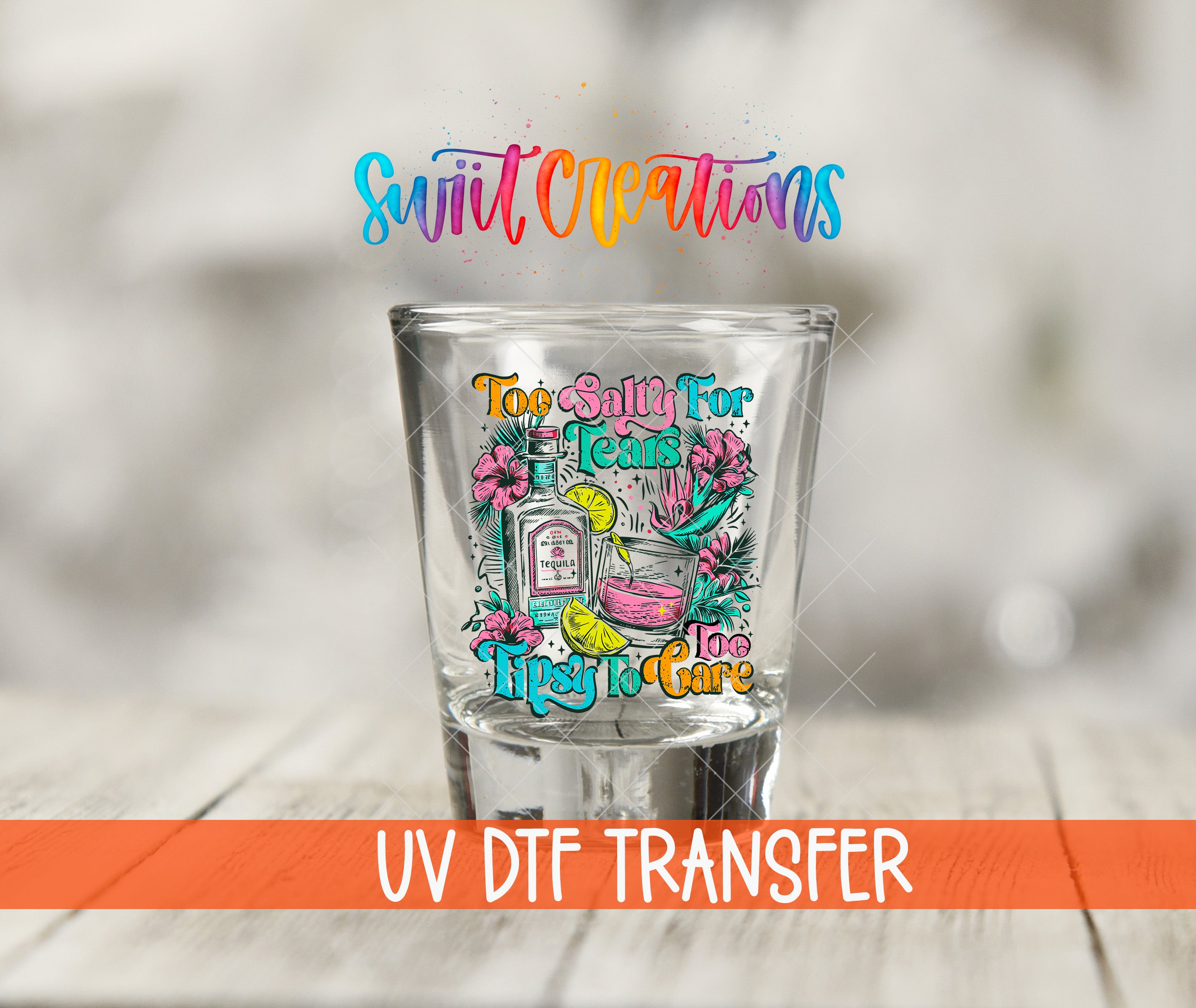 A colorful shot glass with a vibrant design, placed on a wooden surface.