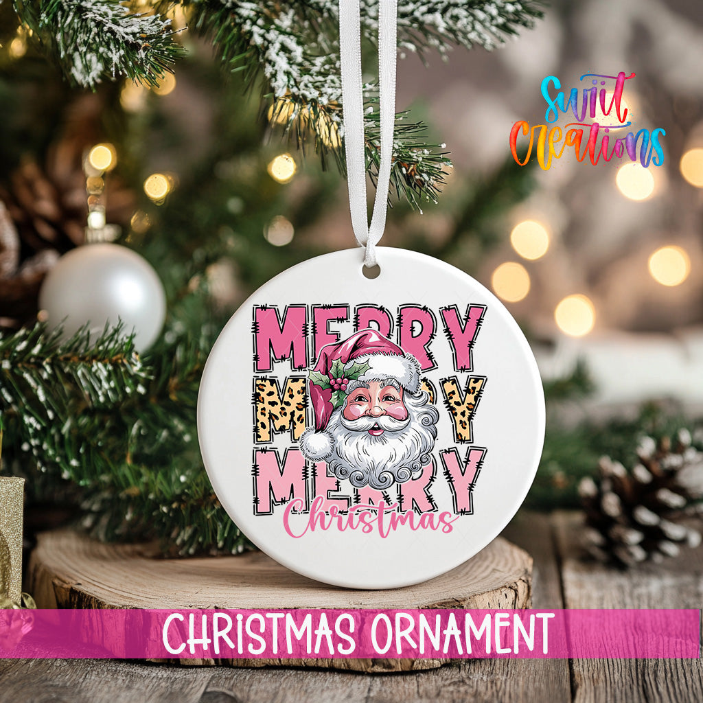 A white Christmas ornament with a Santa Claus face and the text "MERRY MARY CHRISTMAS" is hanging on a tree.