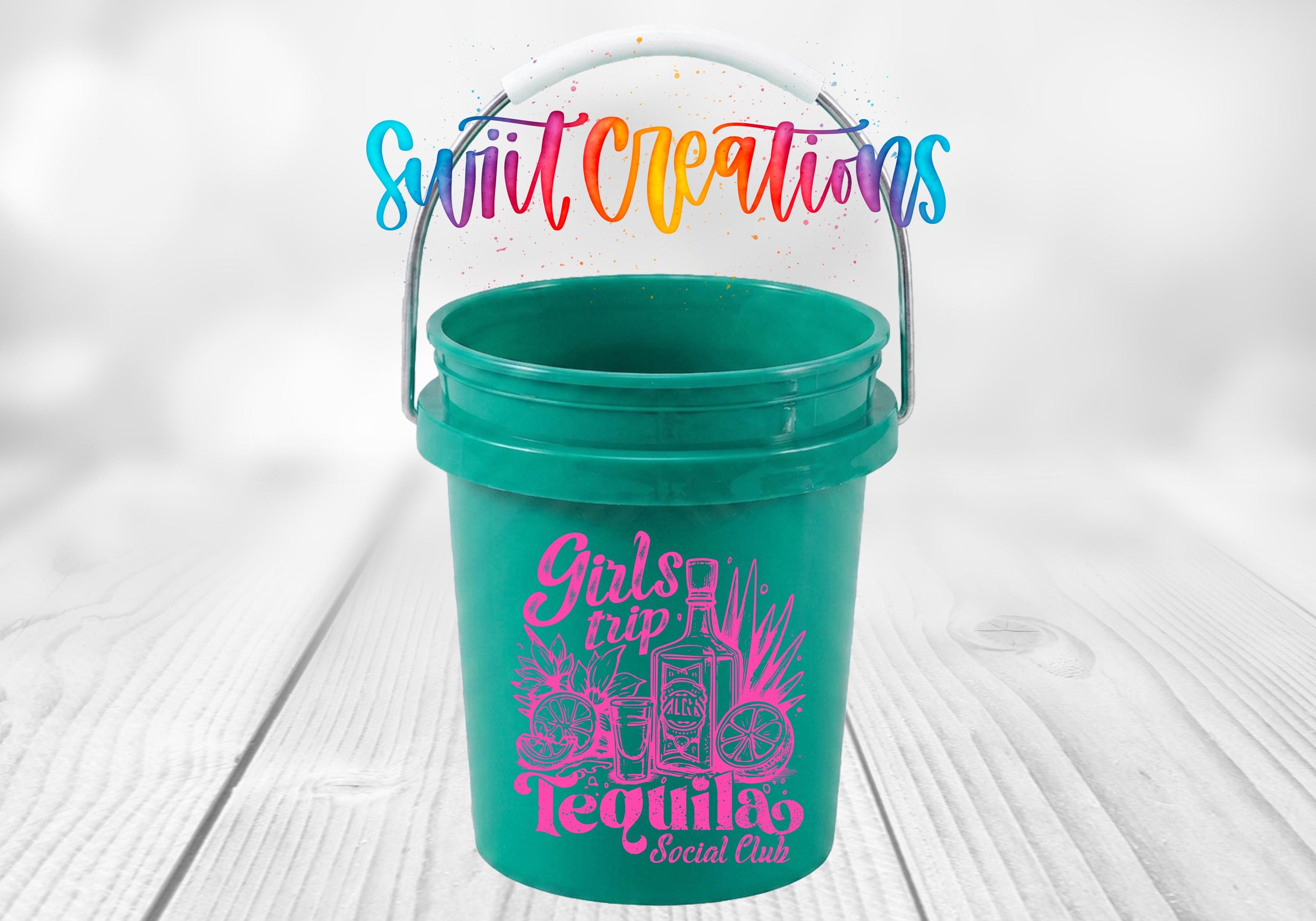 A green plastic bucket with a handle, featuring a colorful design and text that says "Girls trip tequila social club".