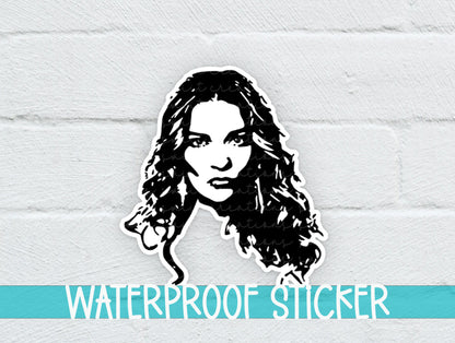 Alexis Portrait sticker on a white brick background with a waterproof sticker banner