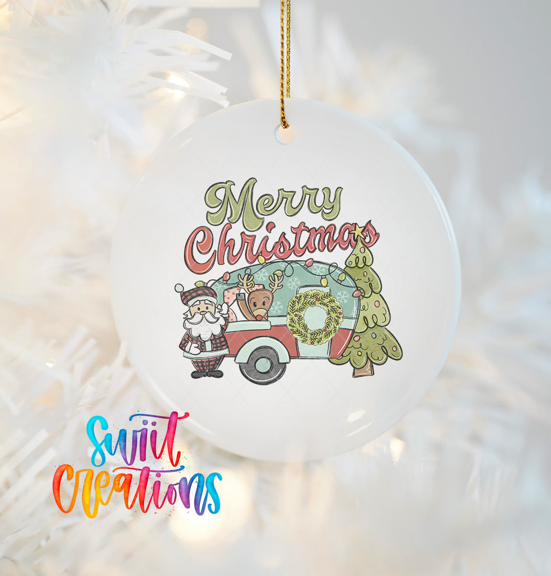 A white Christmas ornament with a Santa Claus figure and a camper van, along with the text "Merry Christmas" and "Suitable Creations" printed on it.