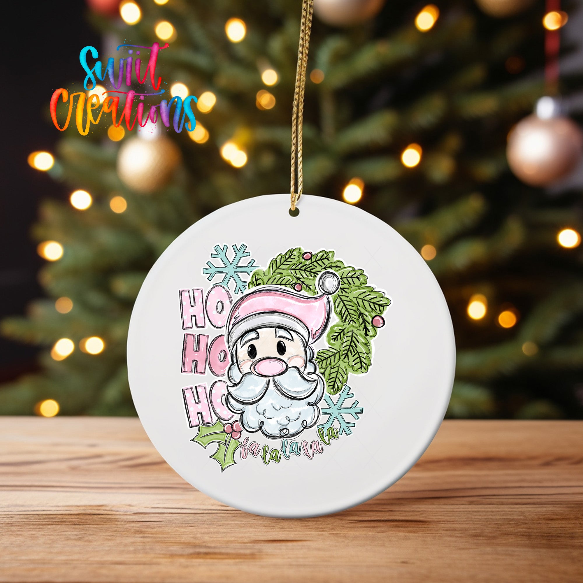A white ceramic ornament featuring a cartoon Santa Claus with a pink hat and the text "HO HO HO" is hanging on a string.