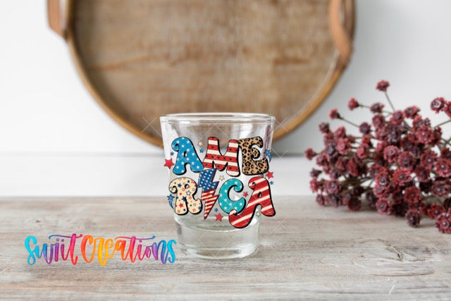 a shot glass sitting on top of a wooden table
