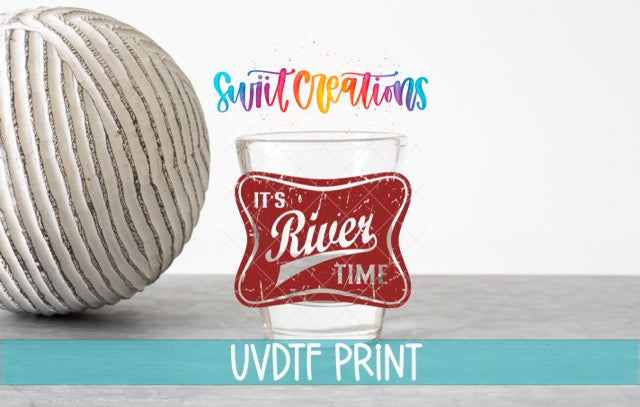 a ball of yarn next to a glass of water