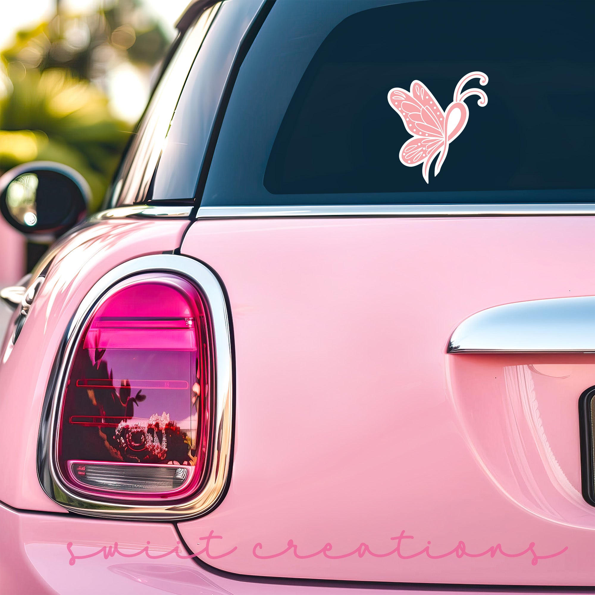 a pink car with a pink butterfly decal on it