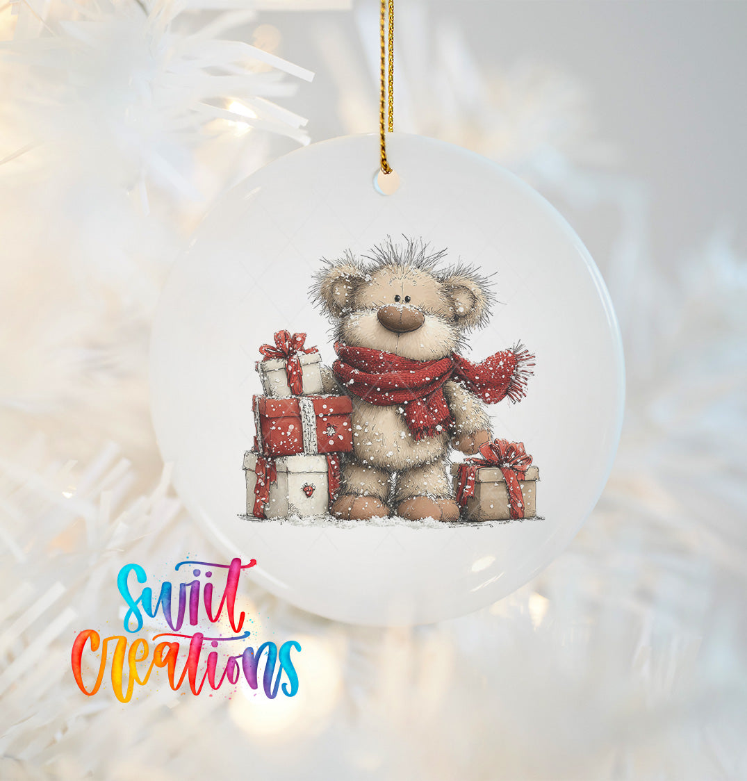 A white ornament with a teddy bear wearing a red scarf and holding a stack of wrapped gifts.