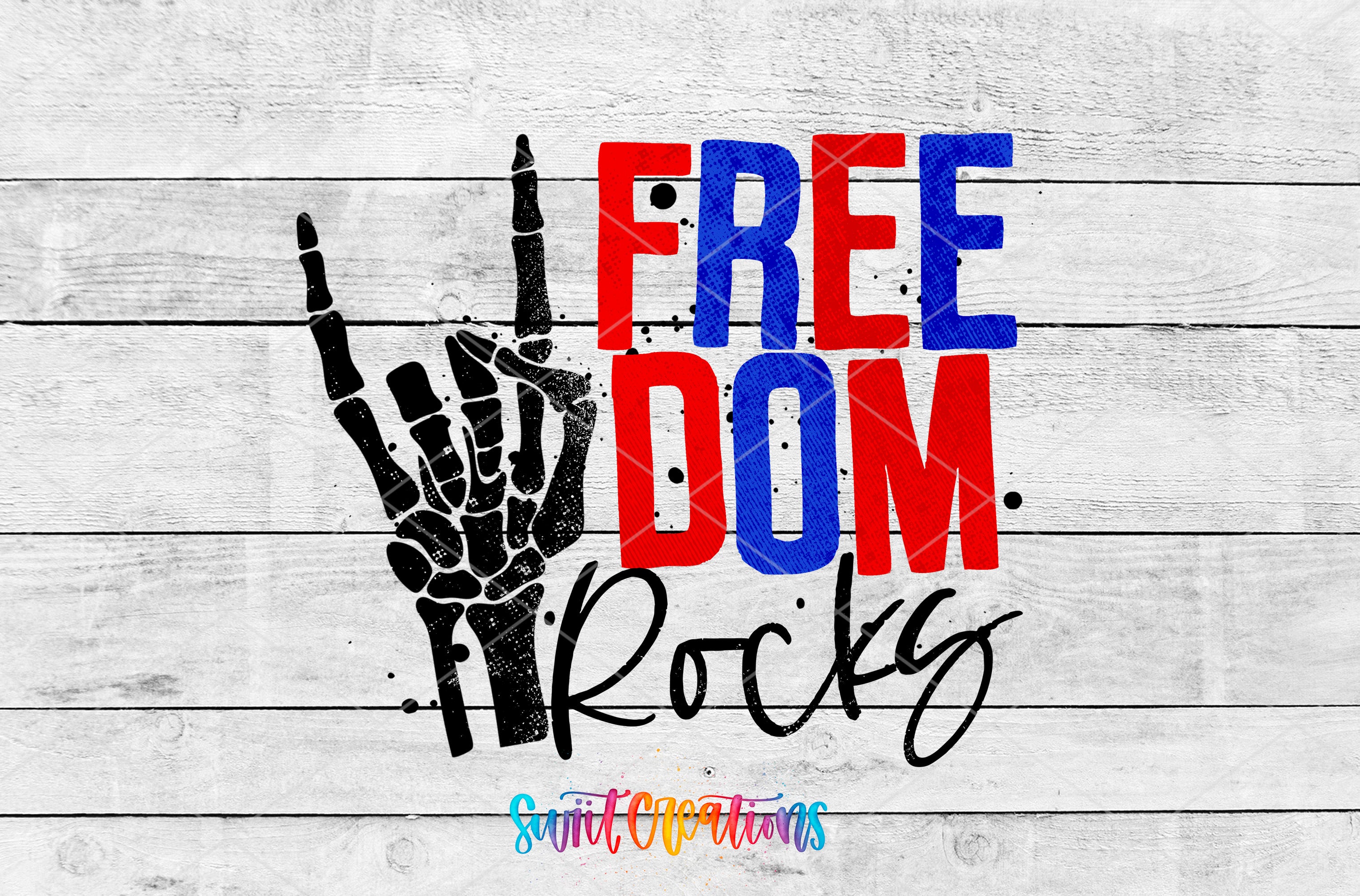 a graphic design with the text "FREE DOM ROCKS" and a skeleton hand gesture, all set against a white wooden background.
