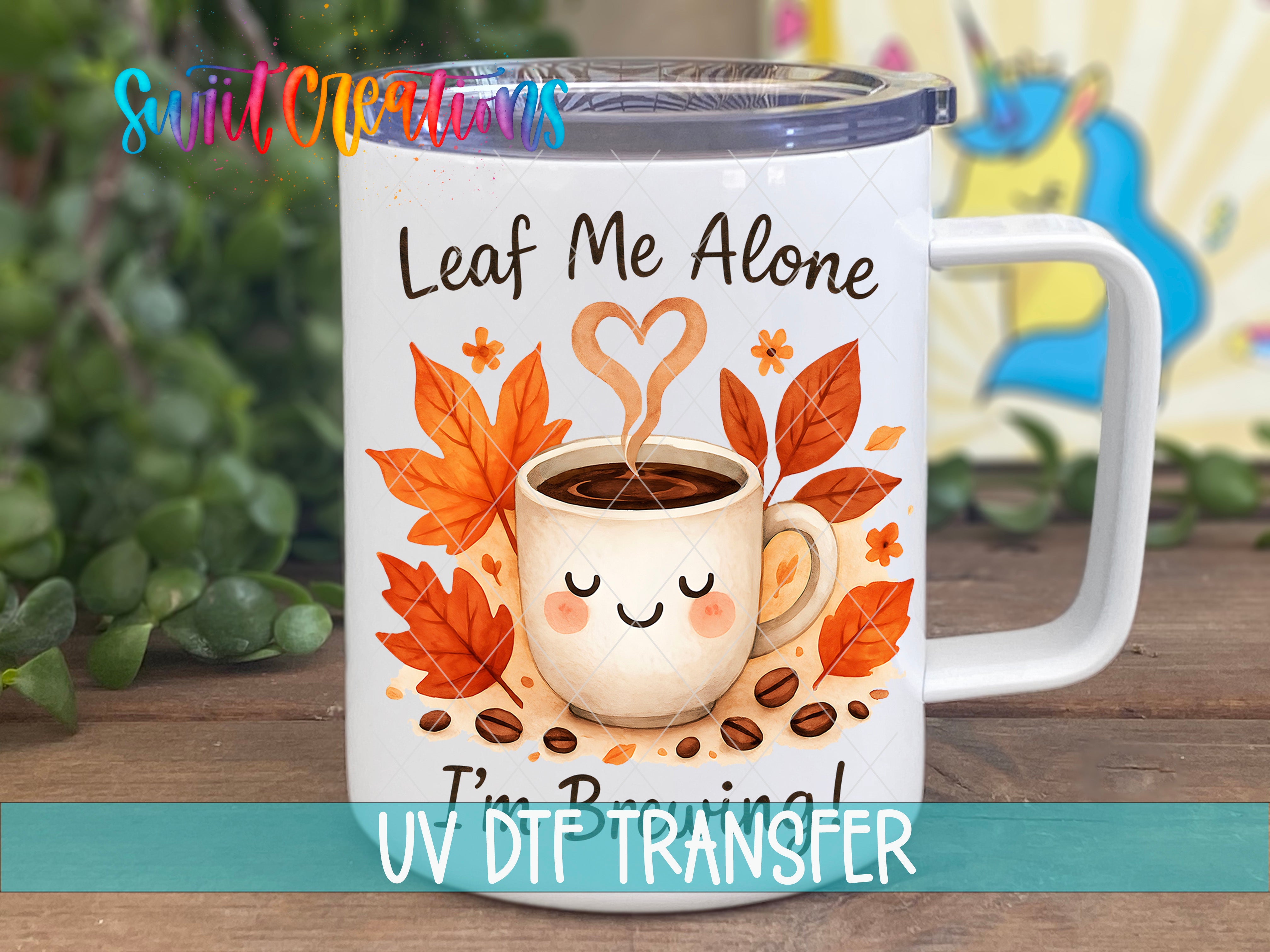 A white ceramic mug with a printed design featuring a coffee cup, leaves, and a heart shape, along with the text "Leaf Me Alone I'm Boring!"