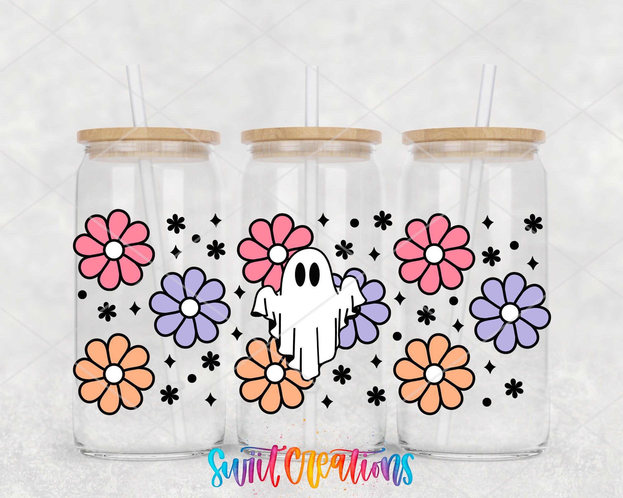 three glass tumblers with a ghost design and colorful flower patterns on them.