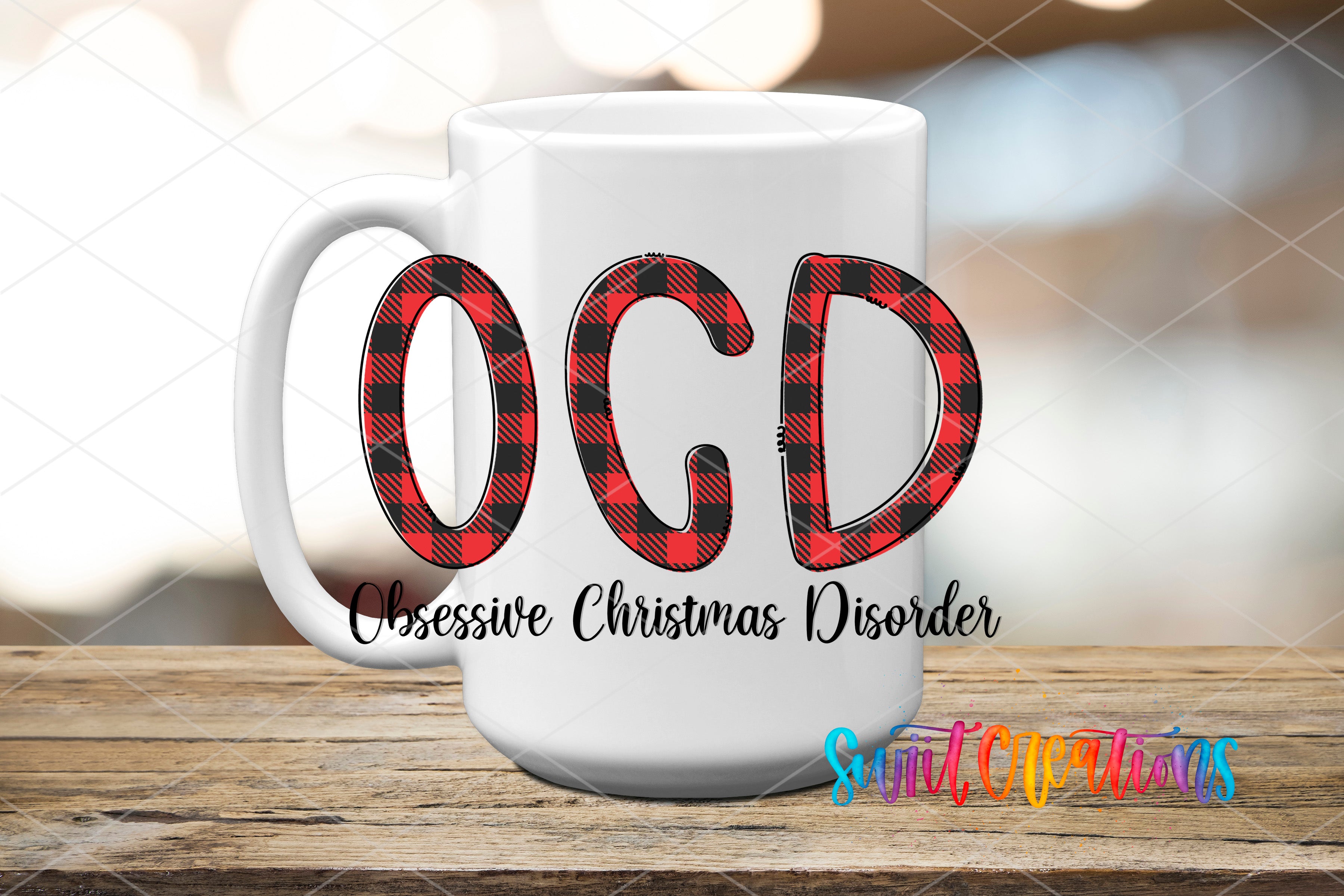 A white mug with the text "OCD" and "Obsessive Christmas Disorder" printed on it, along with a colorful design.