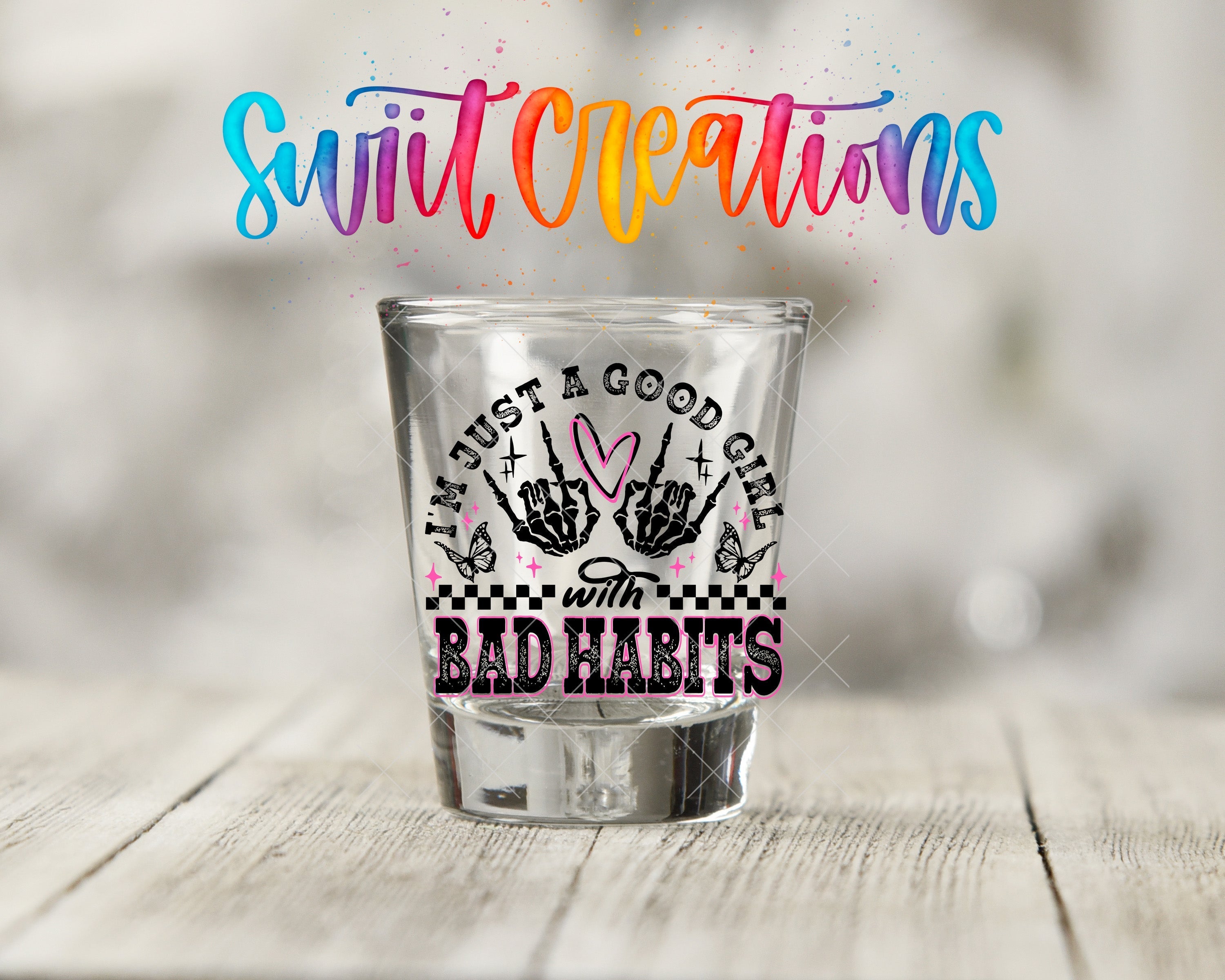 a shot glass sitting on top of a wooden table