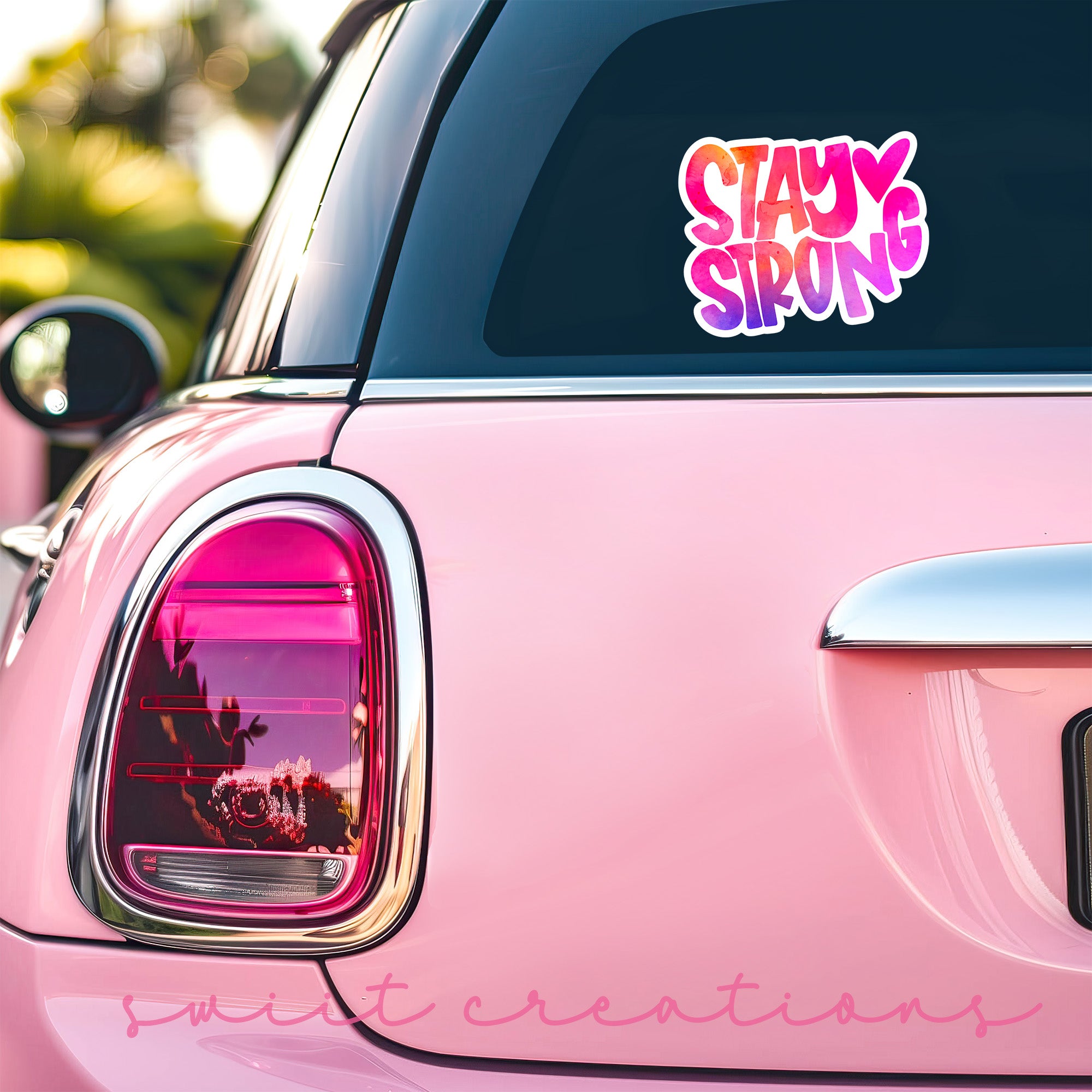 a pink car with a sticker that says stay strong