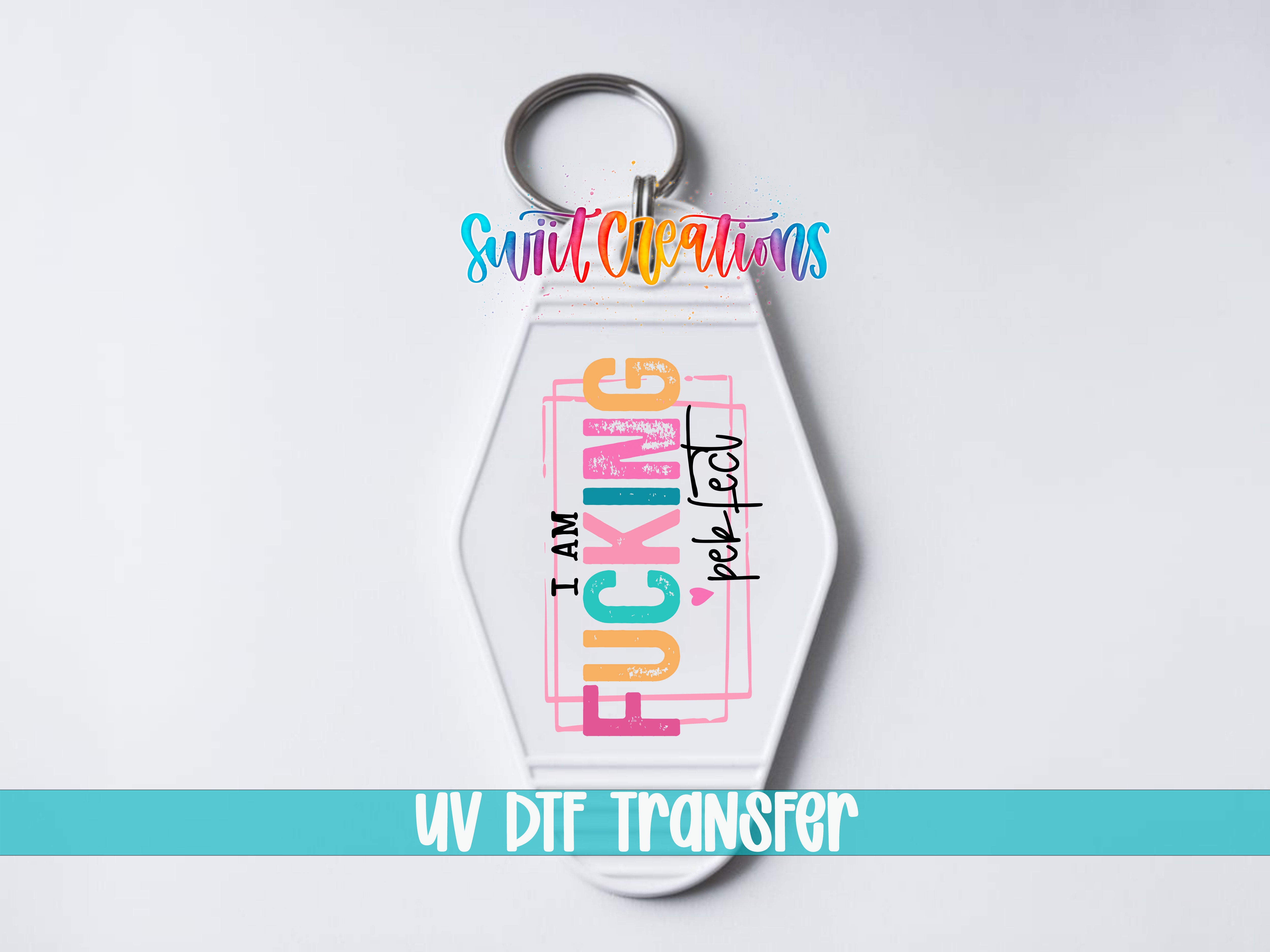A keychain with a colorful, graffiti-style design that says "I AM FUCKING PERFECT" in a stylized font.