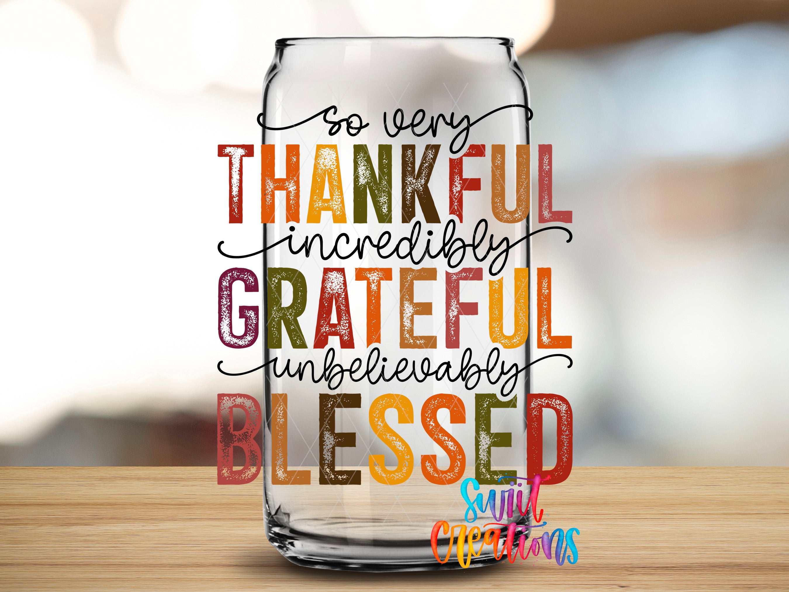 a glass jar with a colorful, handwritten message that reads "So very Thankful incredibly GRATEFUL undoubtedly BLESSED" in a variety of colors.