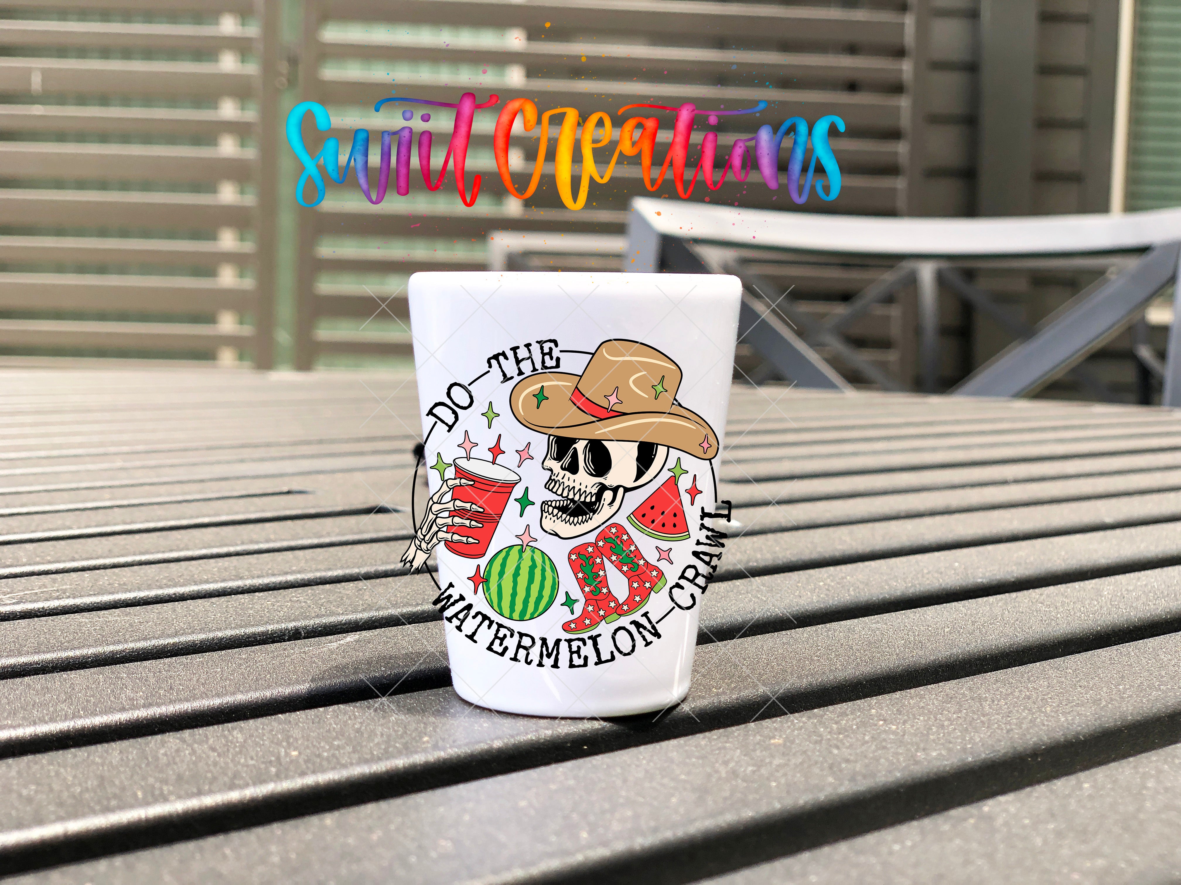 A white mug with a colorful design featuring a skull wearing a cowboy hat and holding a watermelon, along with the text "Do the WATERMELON CRAWL".