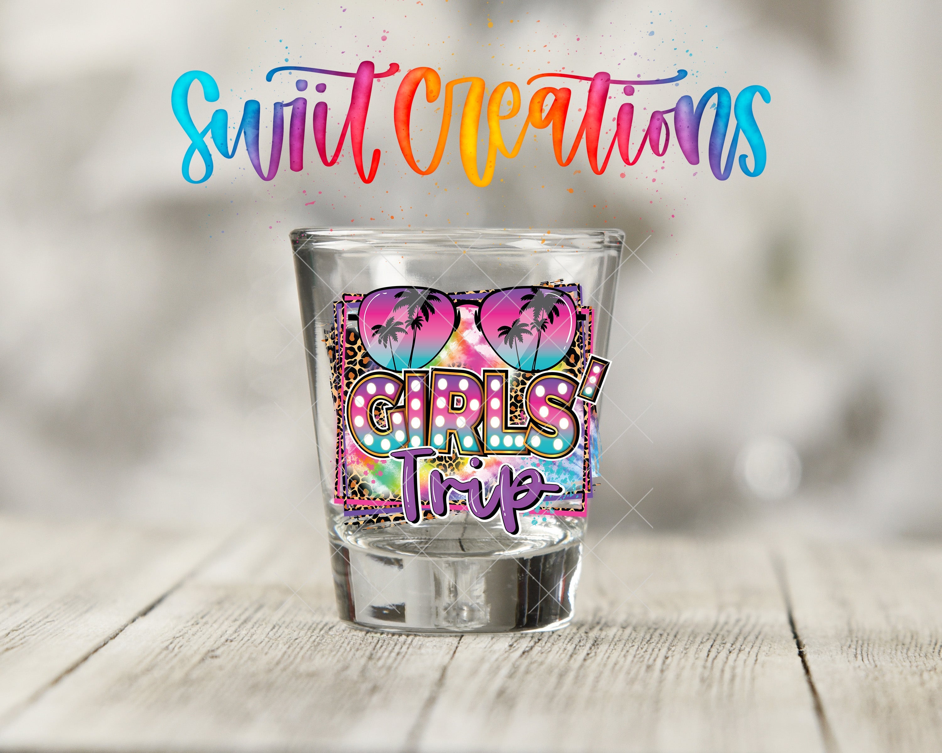 a shot glass sitting on top of a wooden table