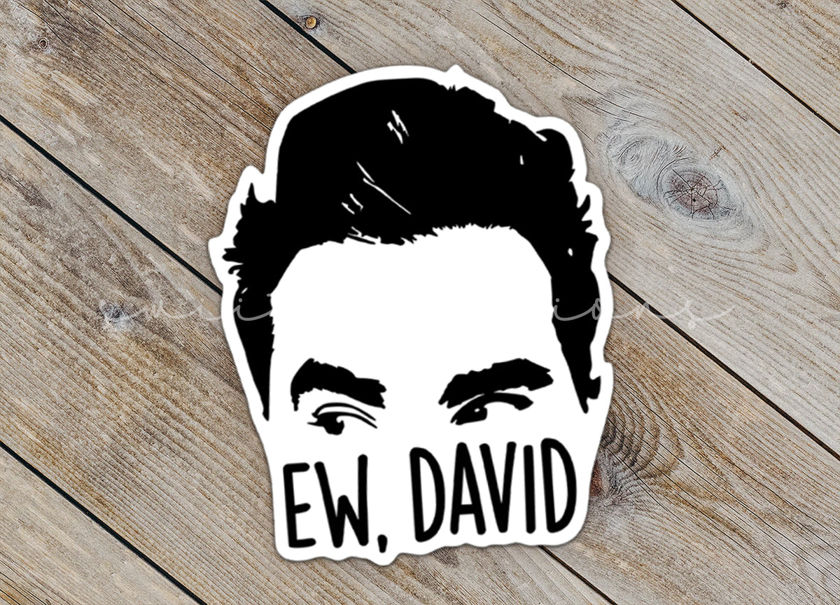 Close-up of the Ew David sticker on rustic wood